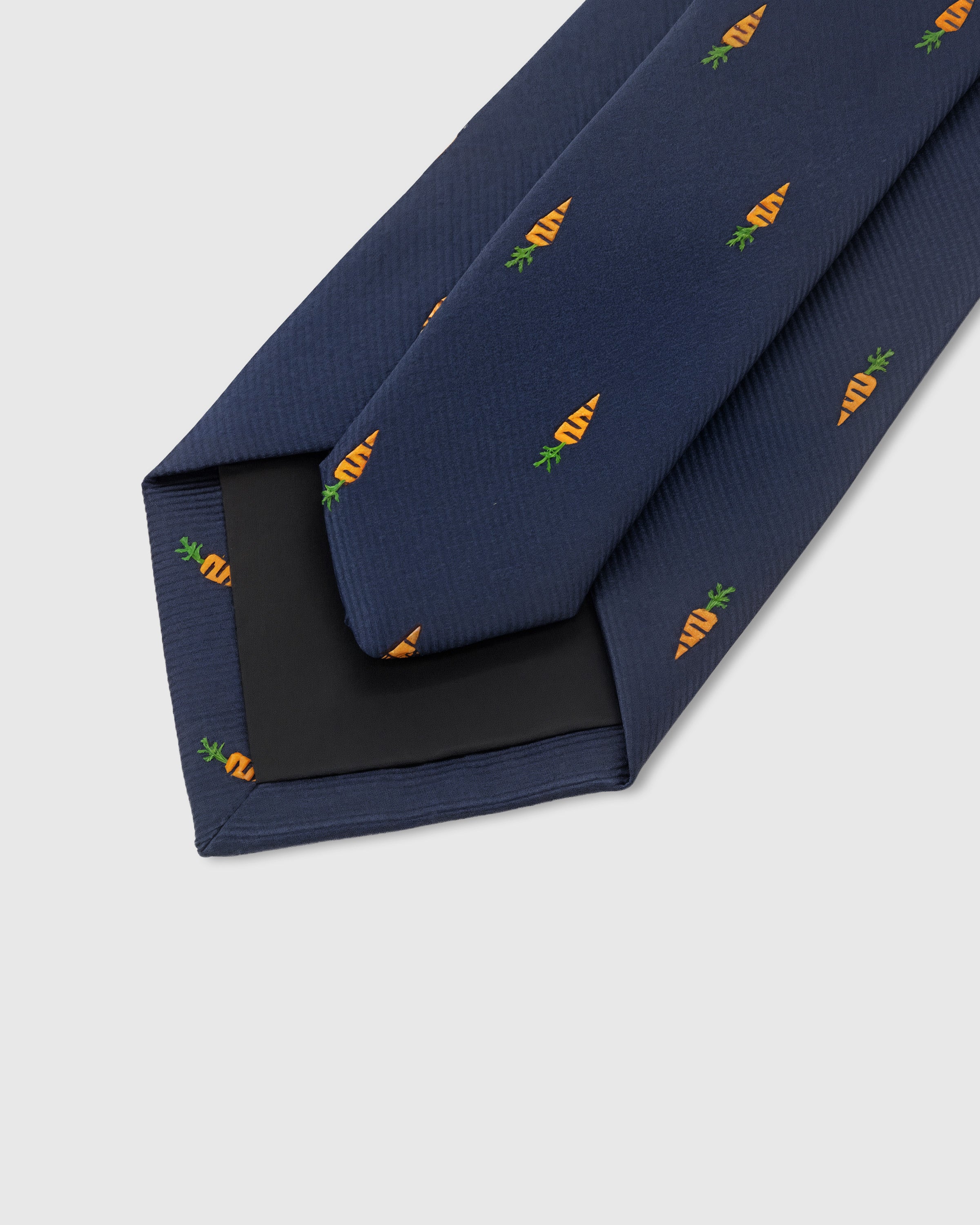 STICKYZOO Navy Carrot Tie showing 45° bias-cut Italian method construction and natural silk drape, 145 × 8 cm