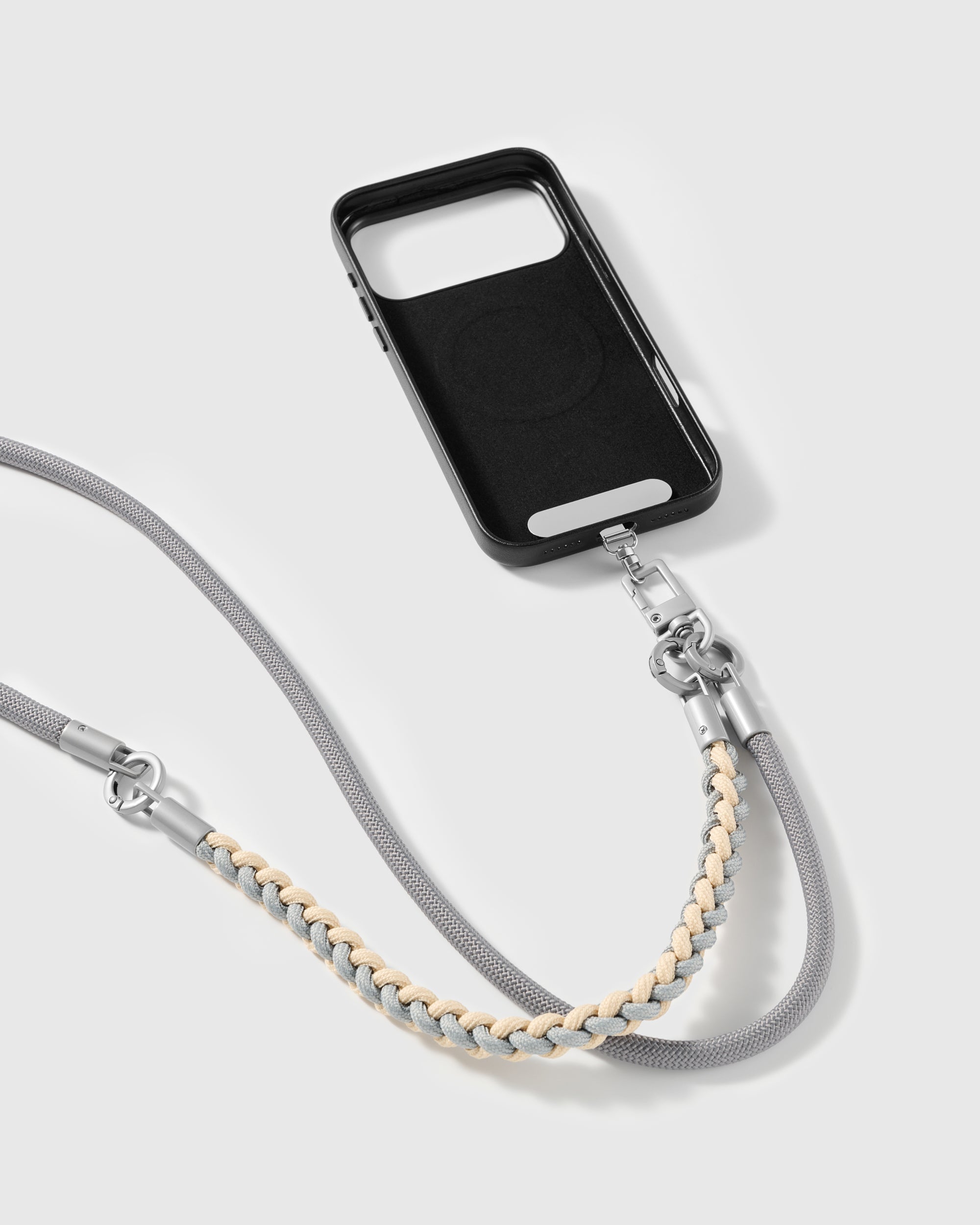 Grey cross-body phone strap clipped to a phone case for hands-free carry