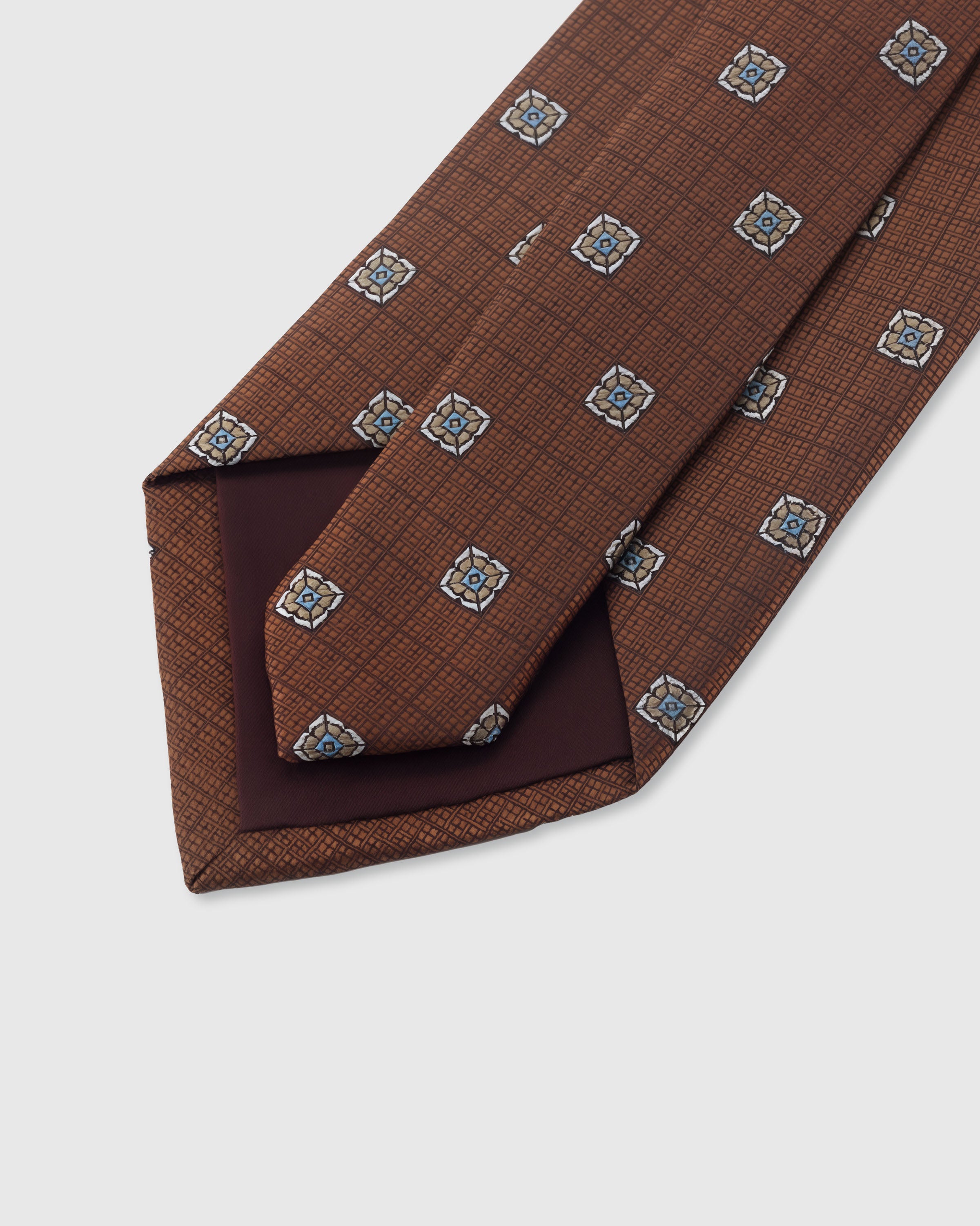{Hand-finished interior} STICKYZOO SIENNA MEDALLION DOT TIE back detail showing structured interlining and hand-finished slip stitching, 145 x 8 cm
