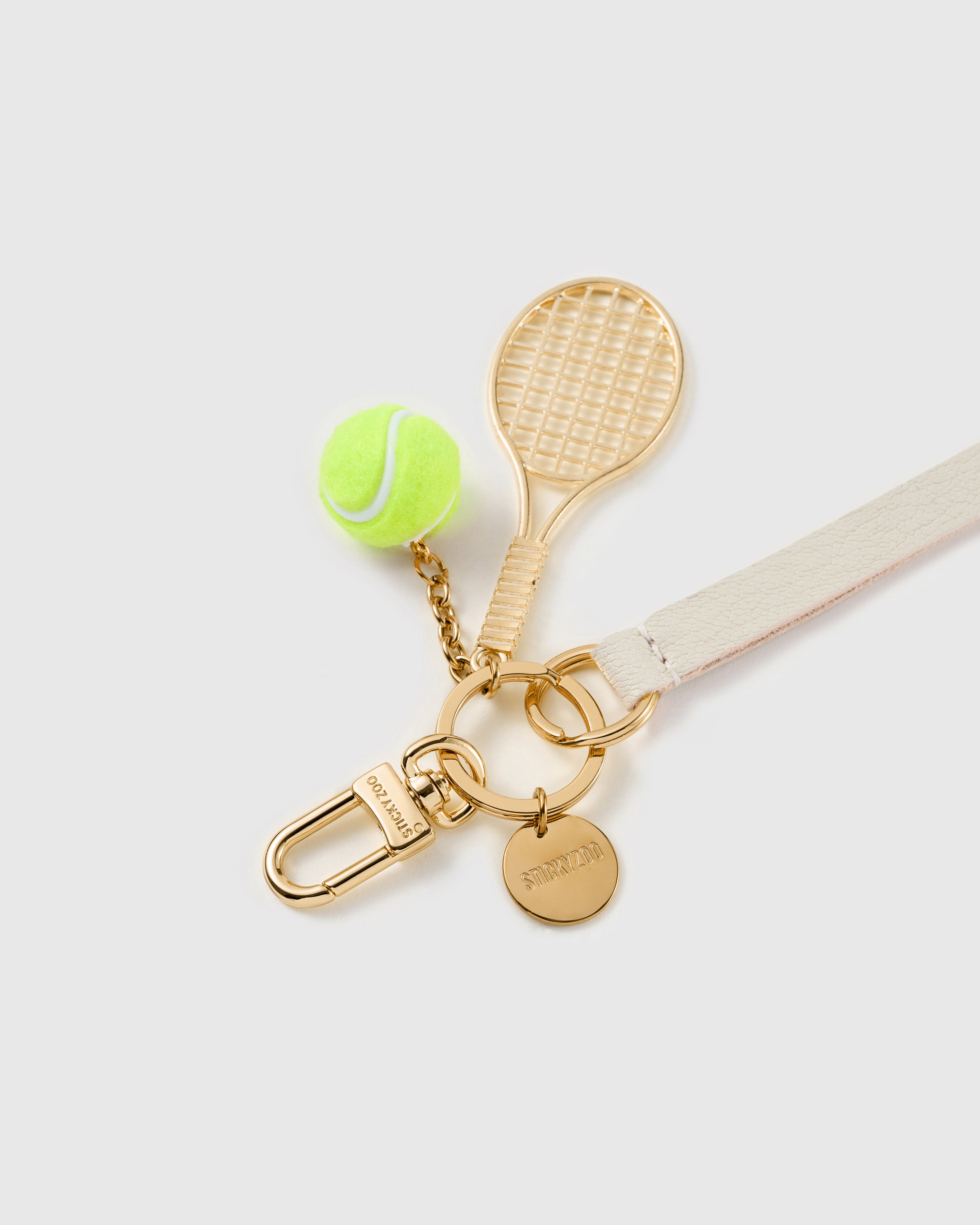 Ivory court leather phone strap clipped to a phone case showing the hands-free wrist loop in use