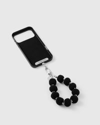 Close-up of silver-tone engraved clasp and STICKYZOO charm disc with black beads