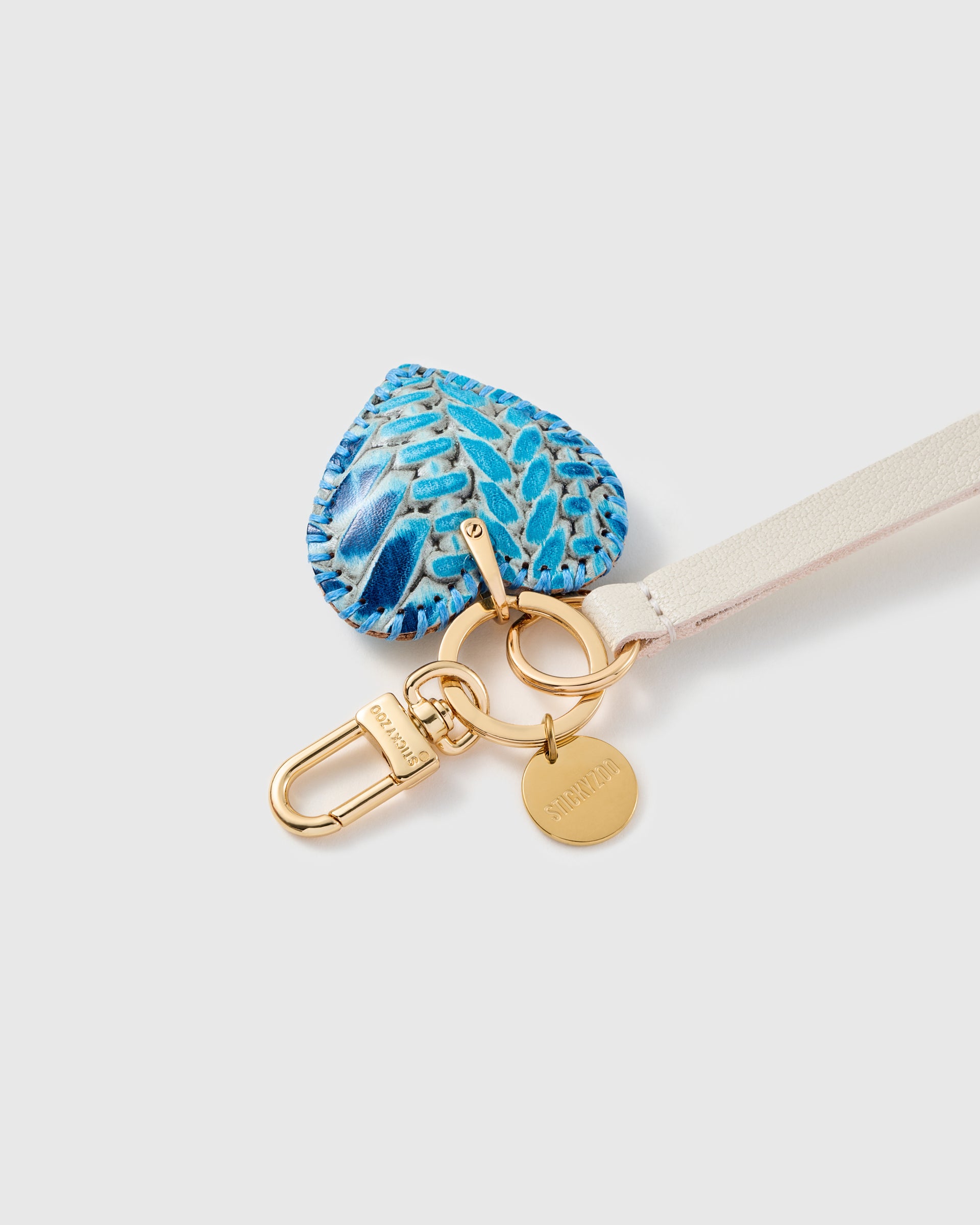 Close-up of the azure python calf-hair heart, hand whip-stitched blue edge and hand-cut leather by STICKYZOO