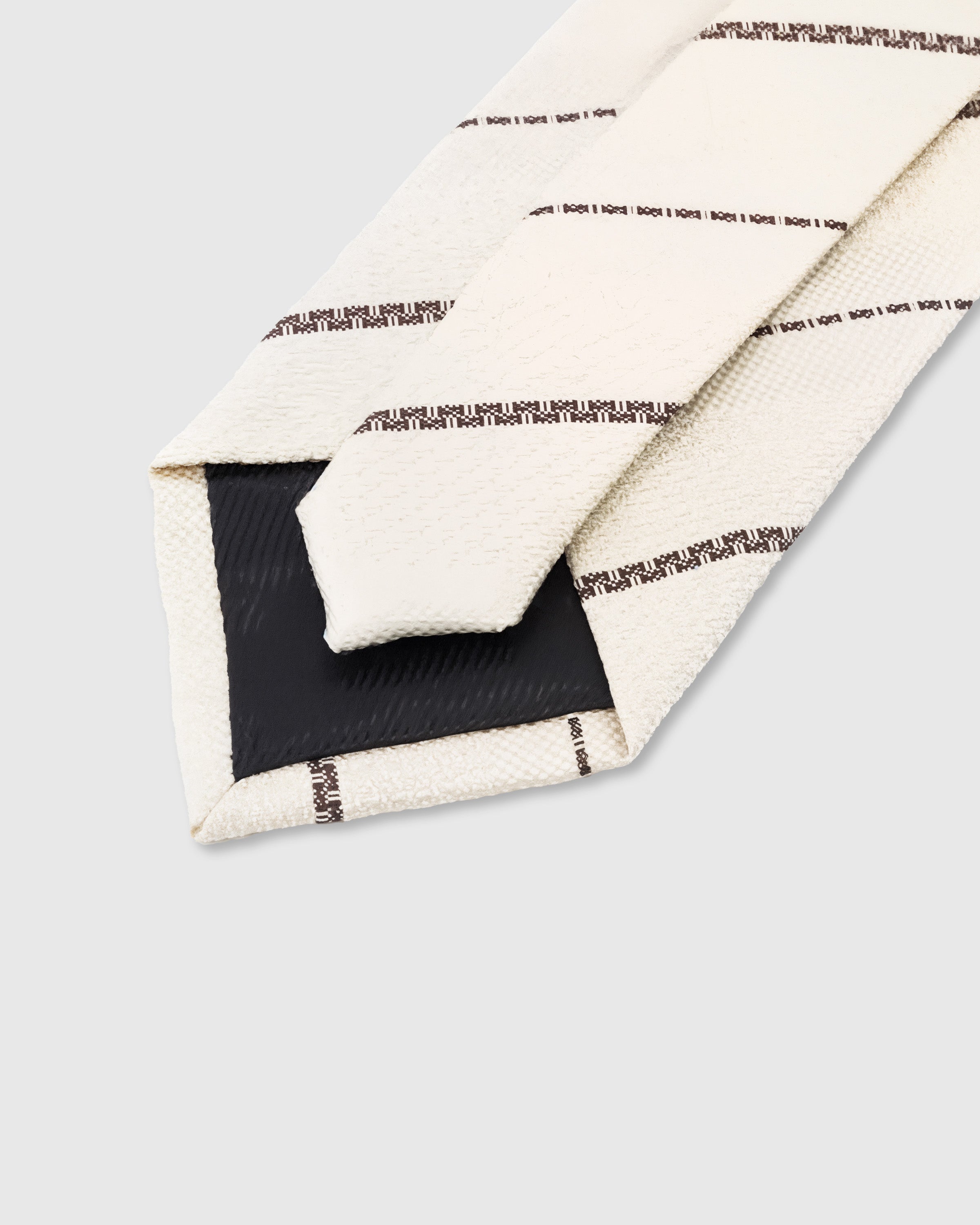 STICKYZOO Ivory Pinstripe Tie construction showing 45° bias-cut Italian method and structured interlining, 100,000+ sold