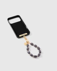 Inside of phone case showing STICKYZOO Phone Strap Card with storm agate strap attached
