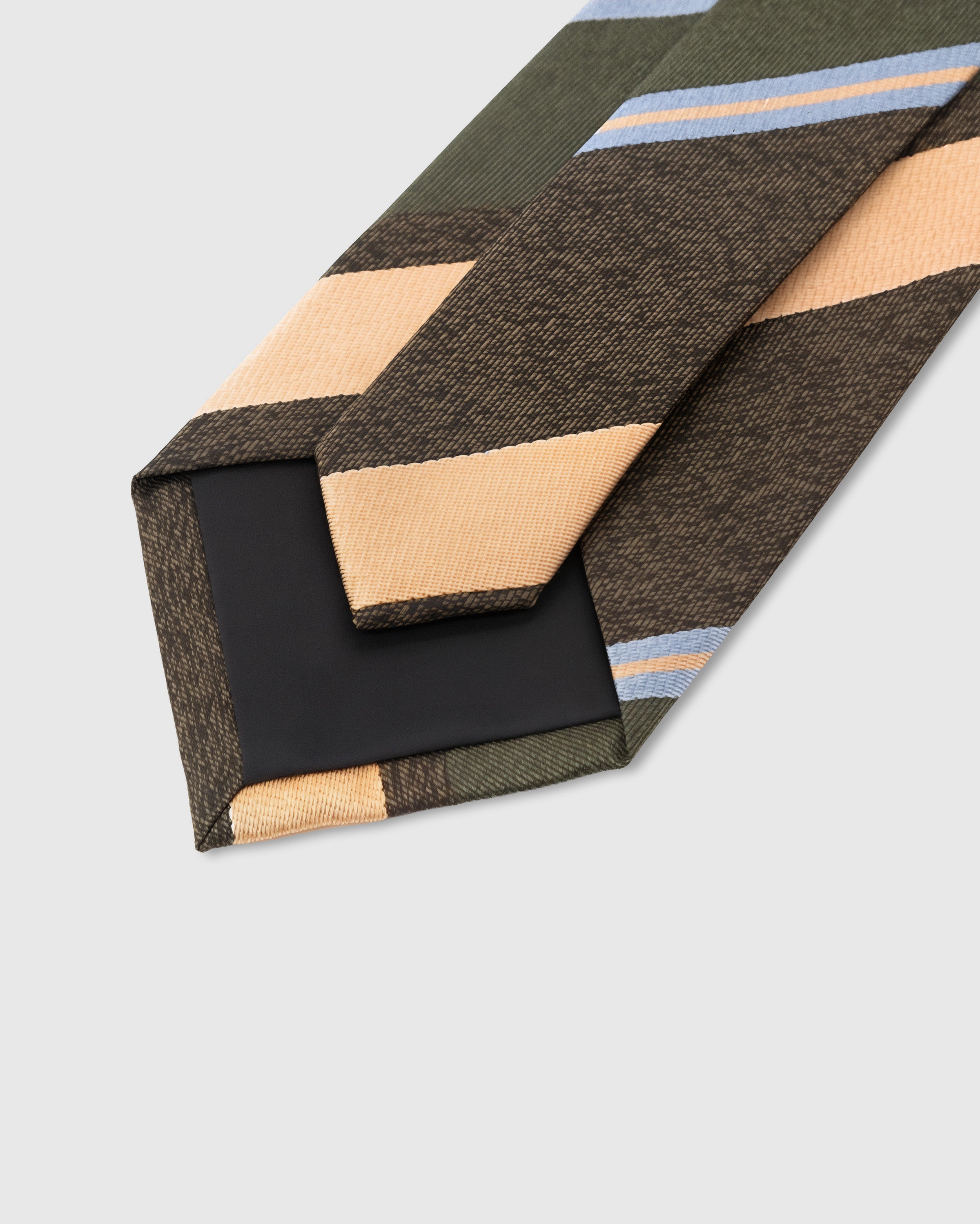 STICKYZOO Ember Regimental Tie interior detail showing structured interlining and hand-finished slip stitching, 145 × 8 cm