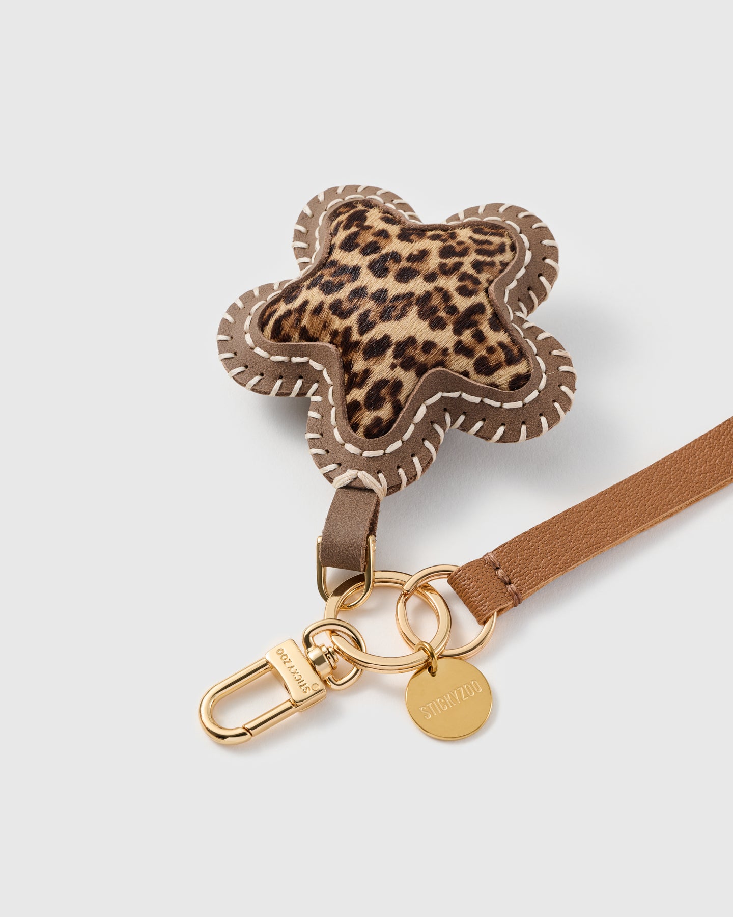 Close-up of the leopard calf-hair star, hand whip-stitched taupe edge and STICKYZOO gold disc