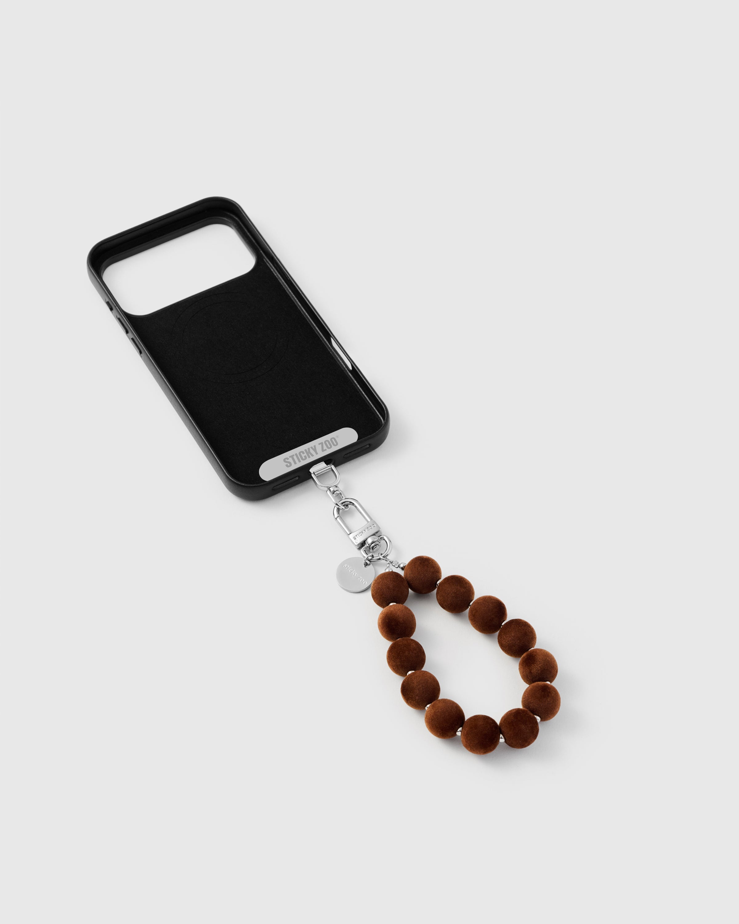 {{Strap Card included}} Inside of phone case showing STICKYZOO Phone Strap Card with toffee pom strap attached