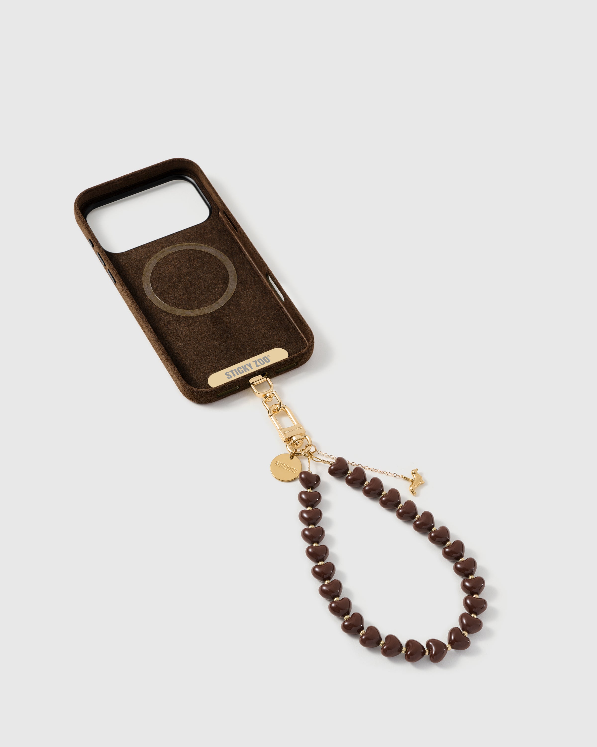 Back of an opened phone case showing the STICKYZOO Phone Strap Card slotted in — universal compatibility. 5,000+ Reviews.
