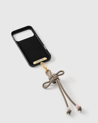 Inside of phone case showing STICKYZOO Phone Strap Card with gold attachment
