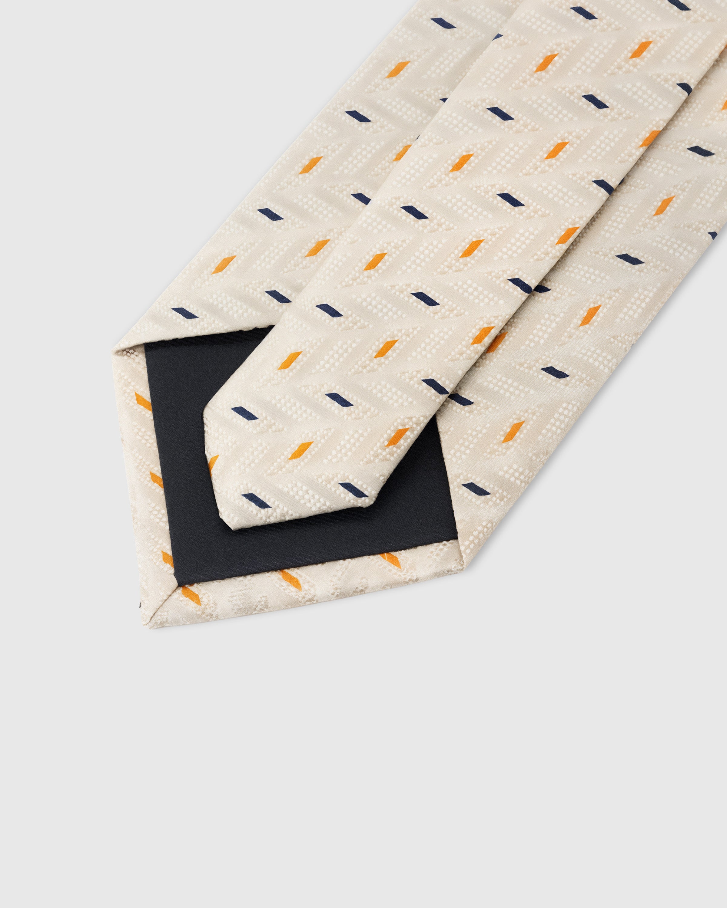 STICKYZOO Pearl Confetti Tie construction showing 45° bias-cut Italian method and structured interlining, 100,000+ sold