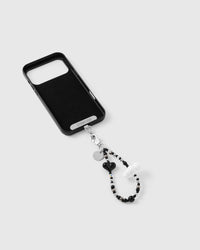 Inside of phone case showing STICKYZOO Phone Strap Card with black heart cloud strap attached