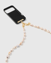 Blush marble link phone strap attached to black phone case showing cross-body carry