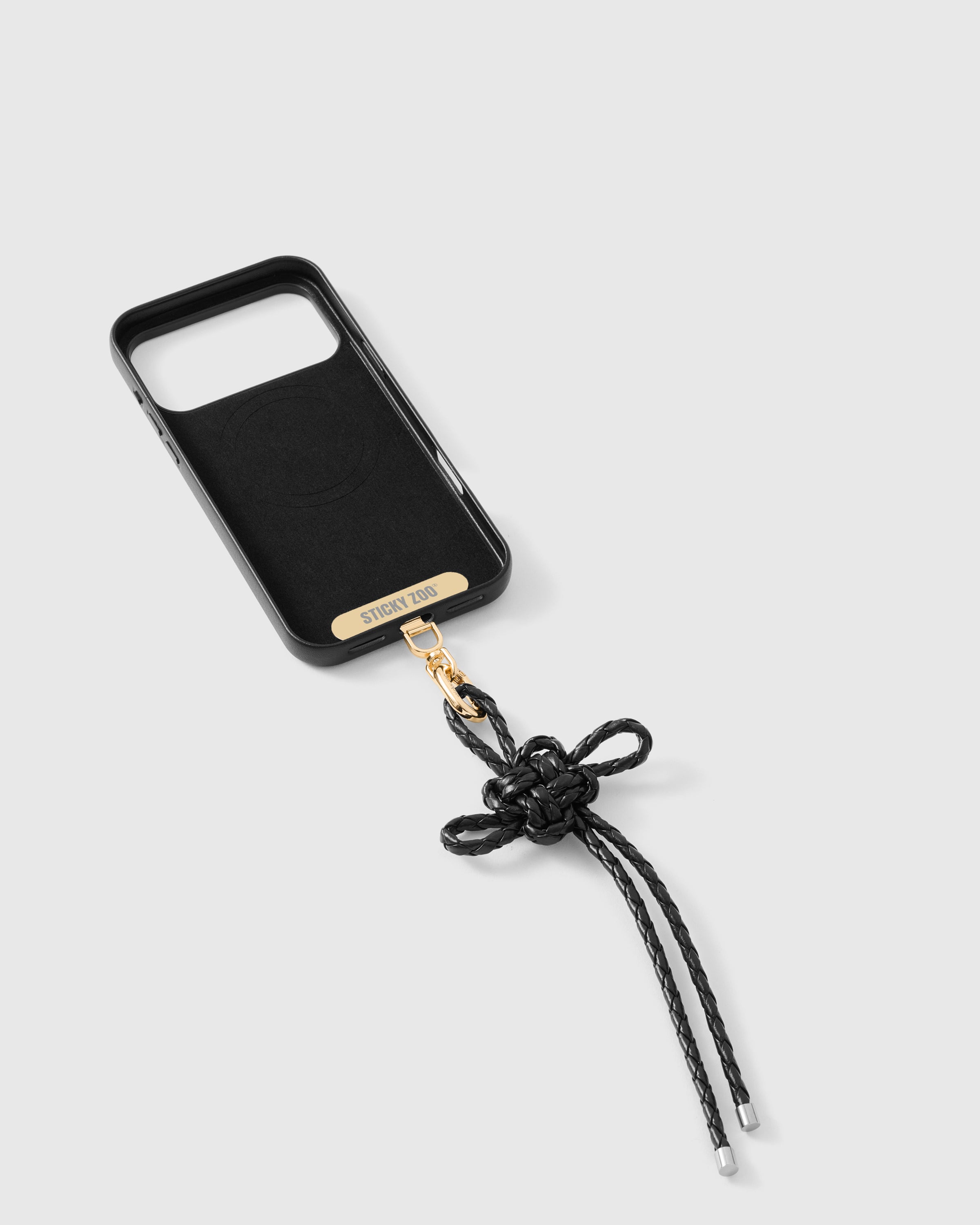 {{Strap Card included}} Inside of phone case showing STICKYZOO Phone Strap Card with noir bow strap connected