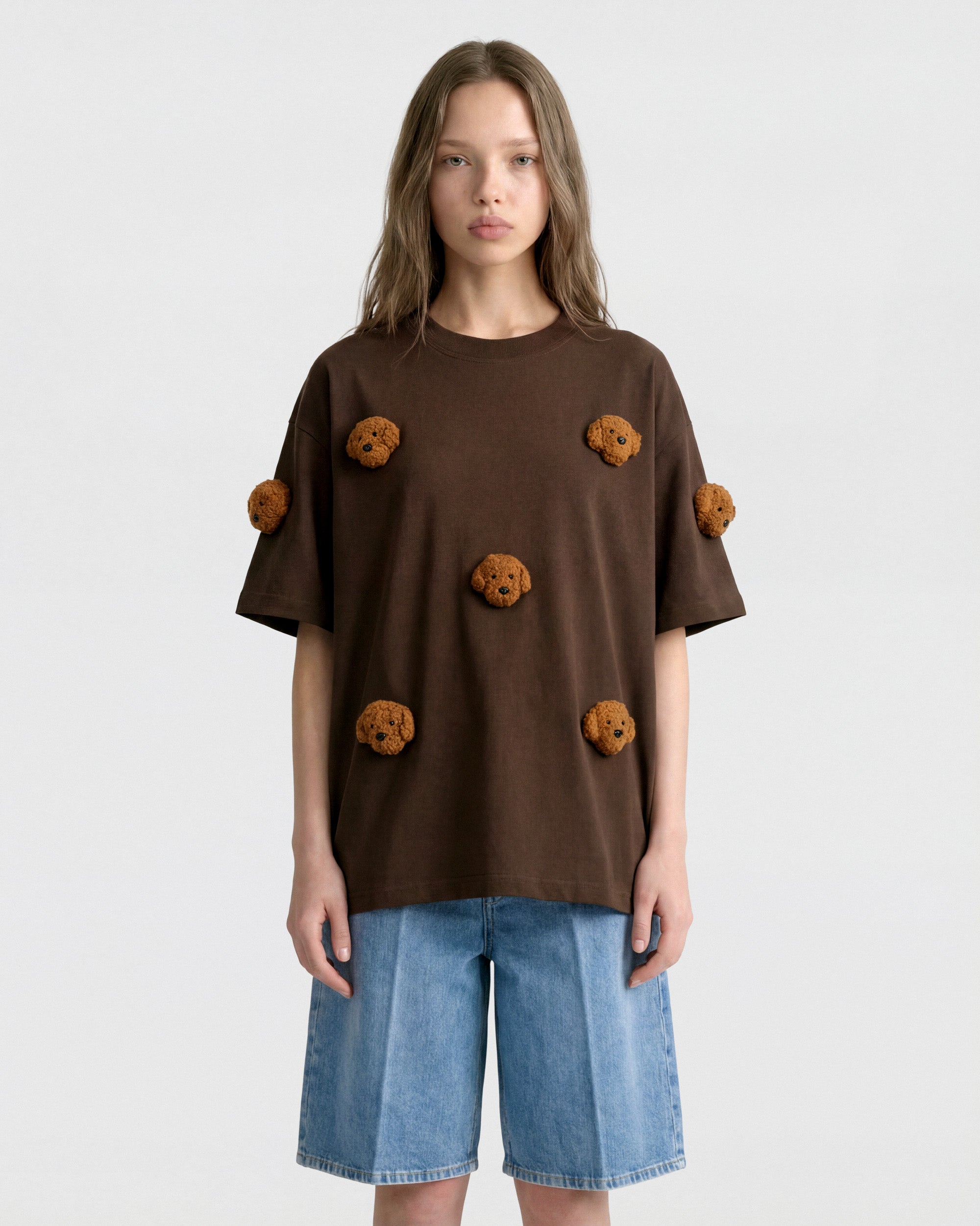 {{Hand-stitched, not print}} Close-up of plush poodle face on brown cotton showing tonal curly 3D texture