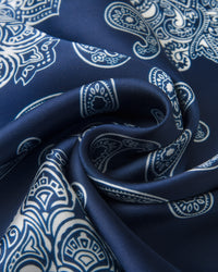 Close-up of the navy silk swirled to show the ivory paisley boteh and the soft drape