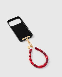 Inside of phone case showing STICKYZOO Phone Strap Card with ruby marble strap attached