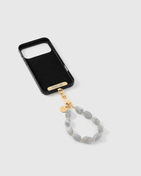 Inside of phone case showing STICKYZOO Phone Strap Card with ash marble strap attached