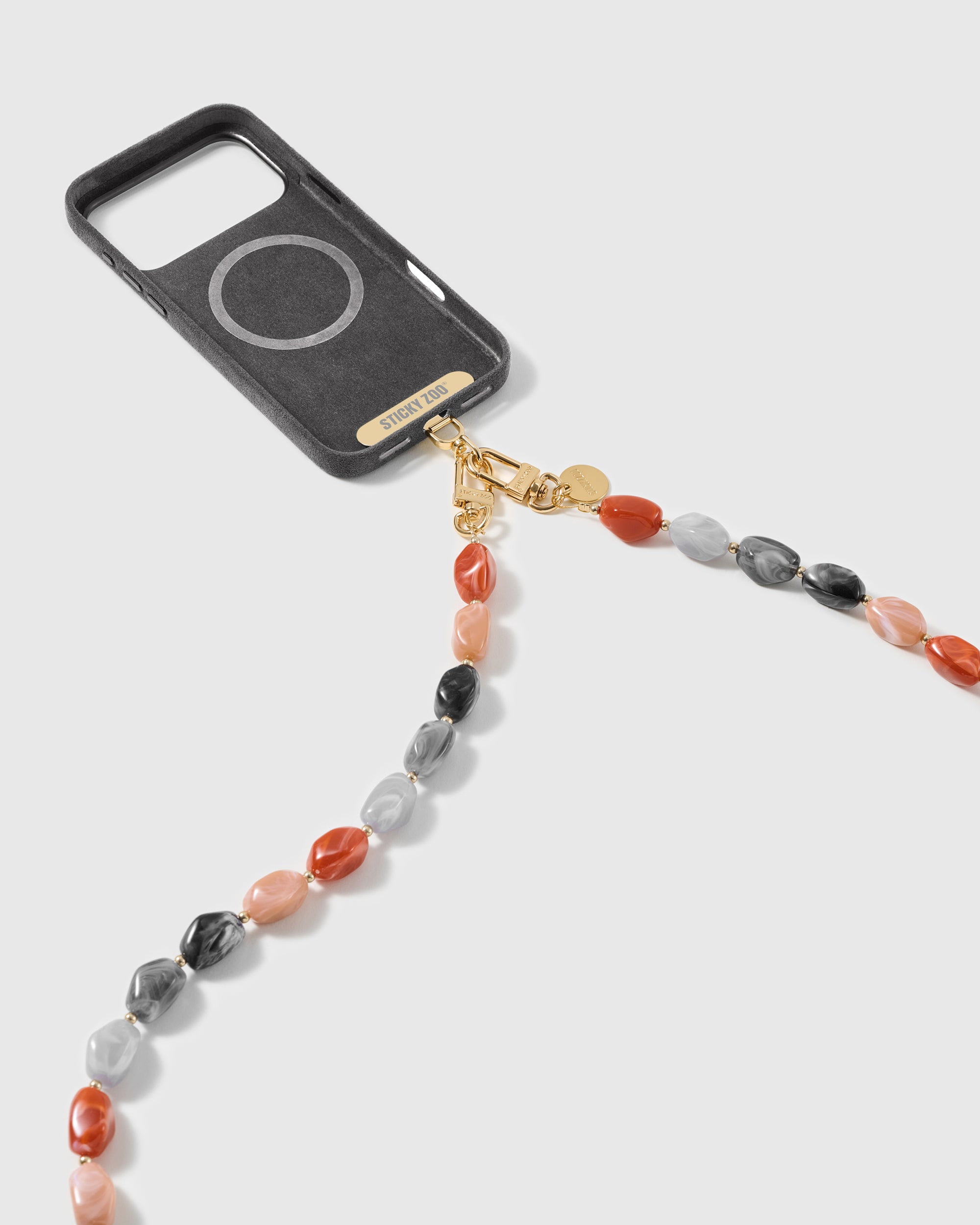 Cross-body strap with dual gold clasps attached to a phone case through the included Phone Strap Card.