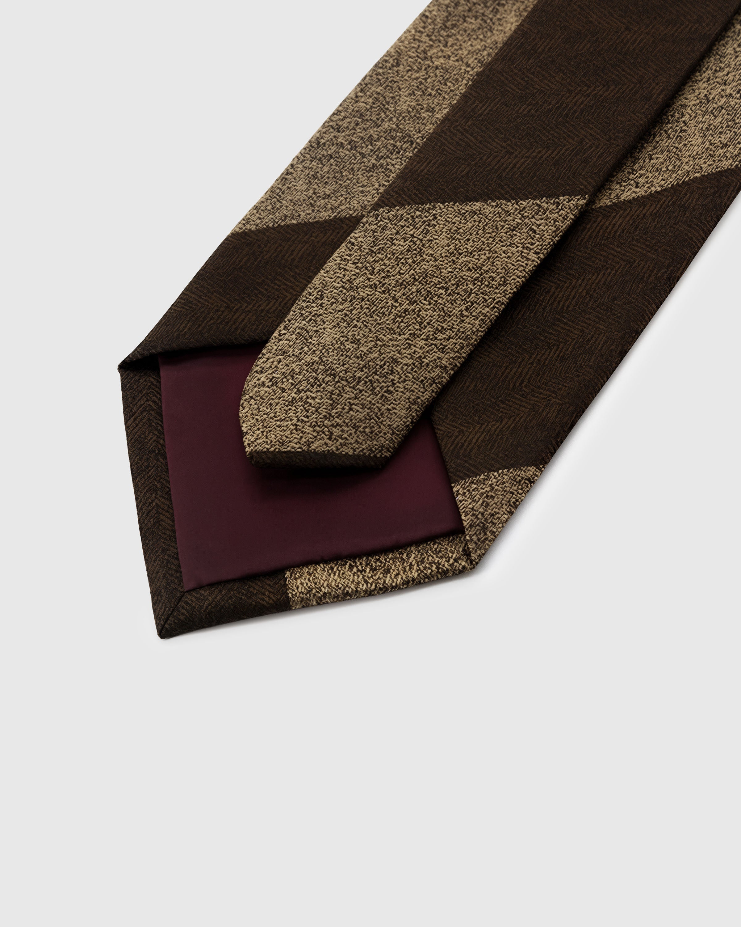 STICKYZOO Espresso Horizon Tie interior showing structured interlining and hand-finished slip stitching, 145 x 8 cm
