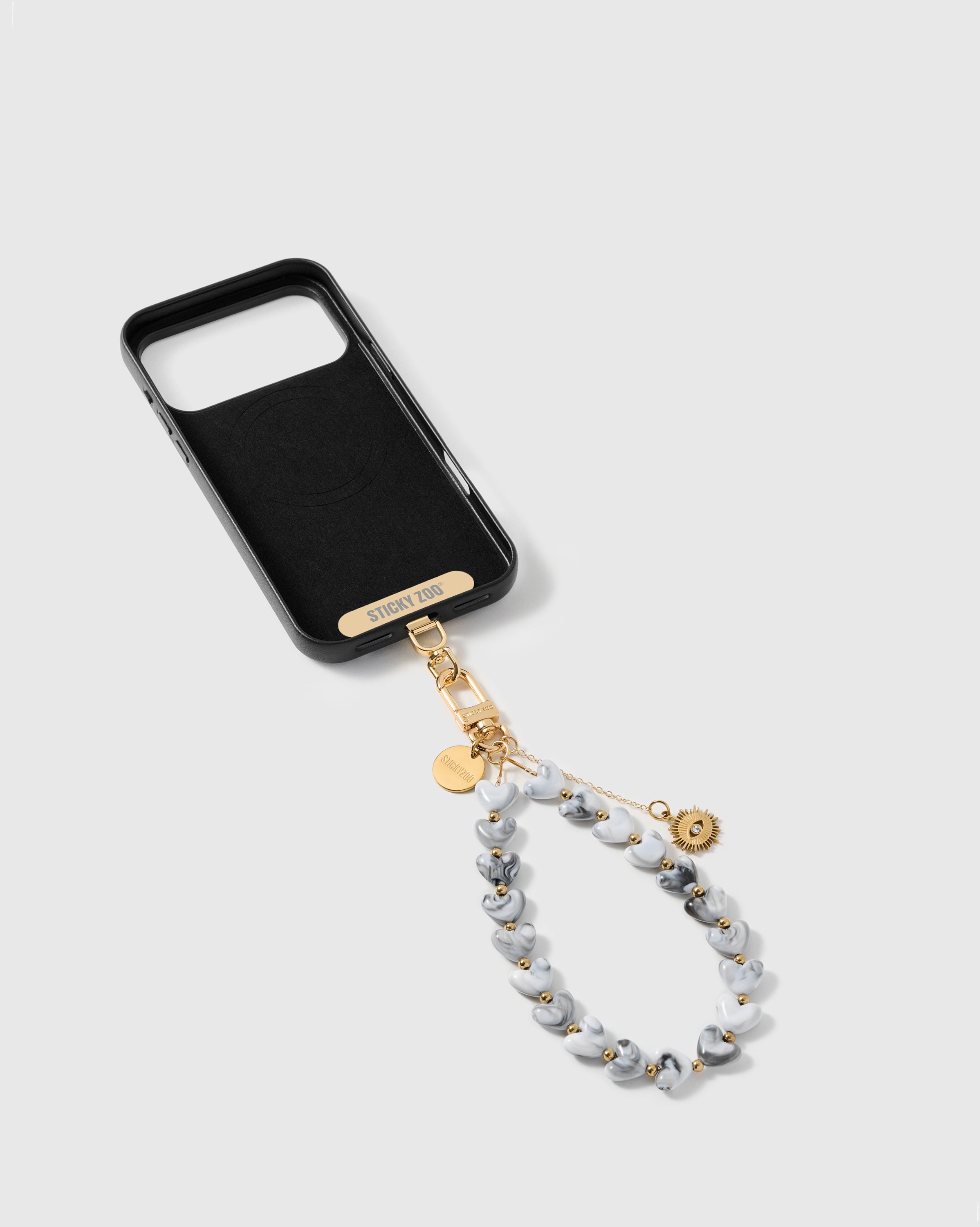 STICKYZOO Phone Strap Card universal adapter shown with the storm eye amulet strap