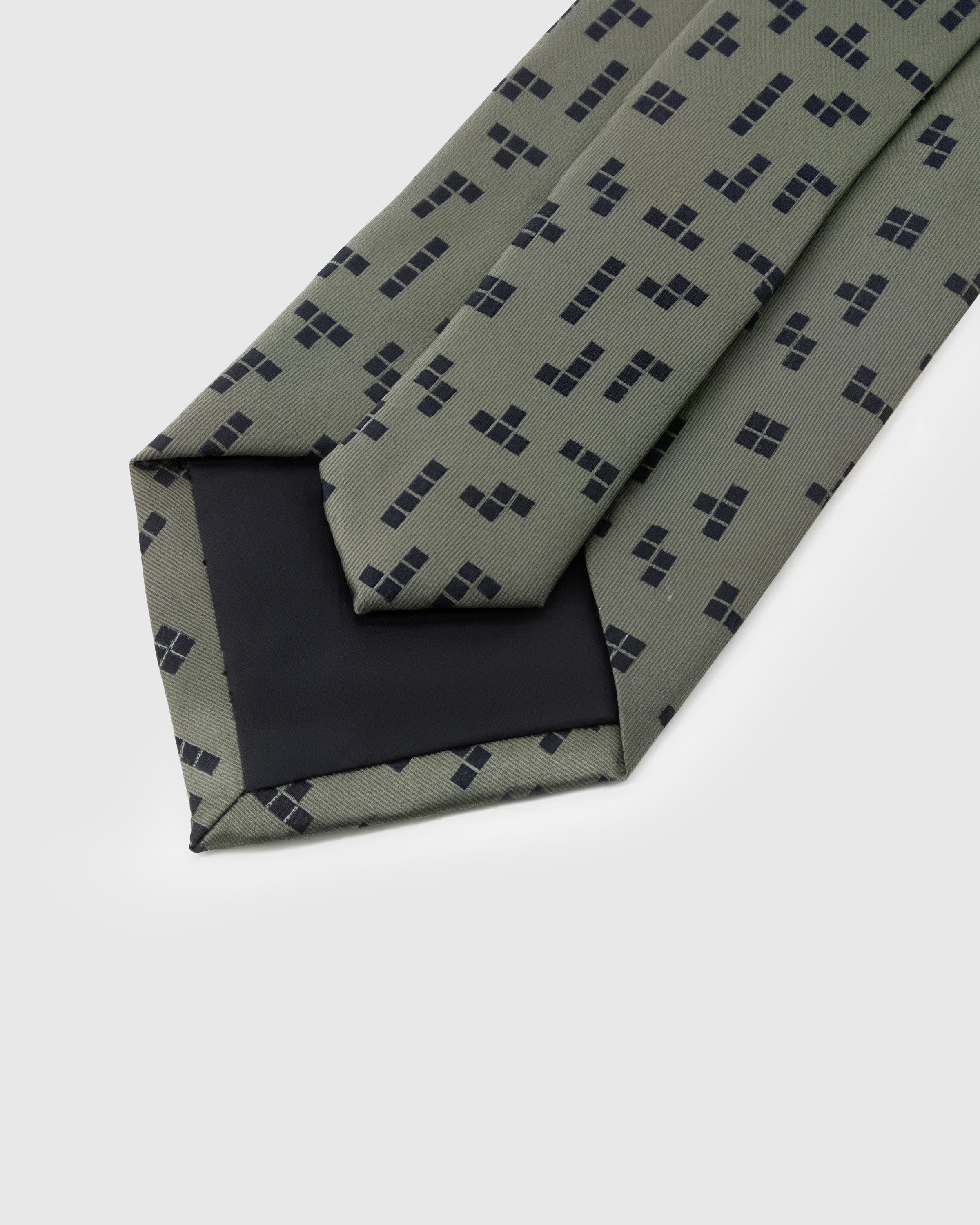 STICKYZOO Sage Geometric Tie construction detail showing structured interlining and hand-finished slip stitching, rated 4.9 stars