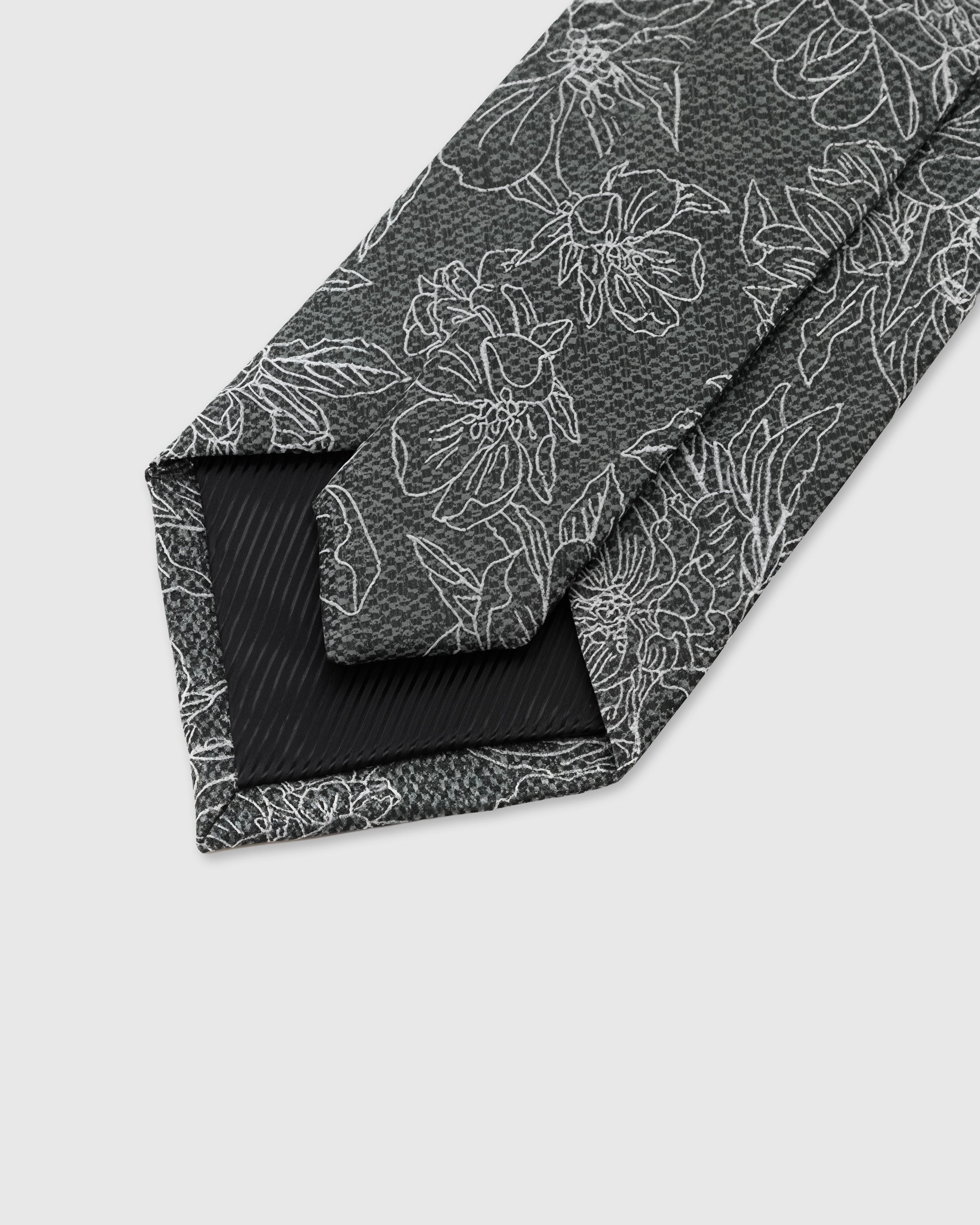 STICKYZOO Slate Botanical Tie interior showing hand-finished slip stitching and structured interlining, 145 × 8 cm