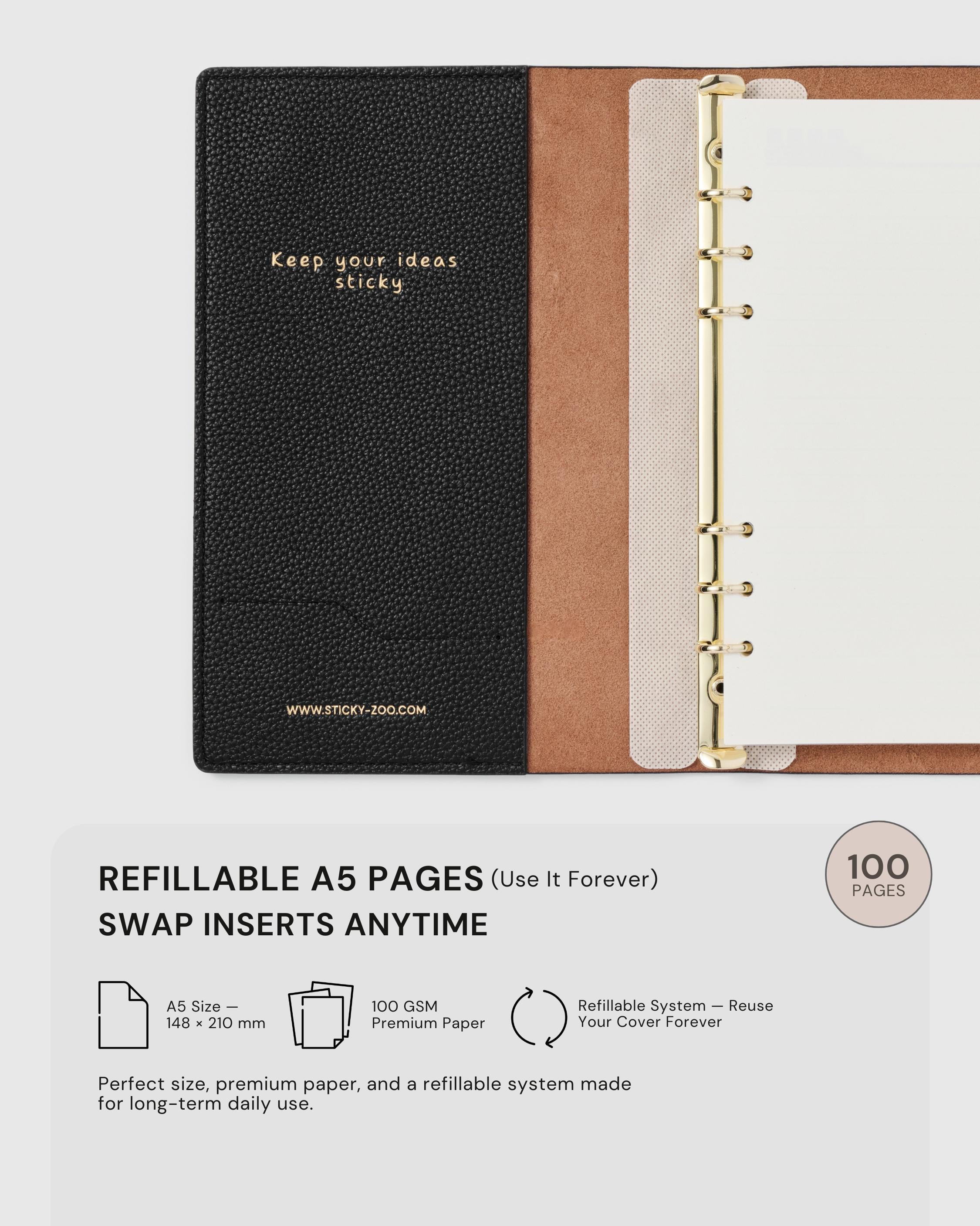 {{Refillable A5 — use forever}} STICKYZOO black leather notebook open showing refillable A5 ring system, 100 GSM premium paper, swap inserts anytime