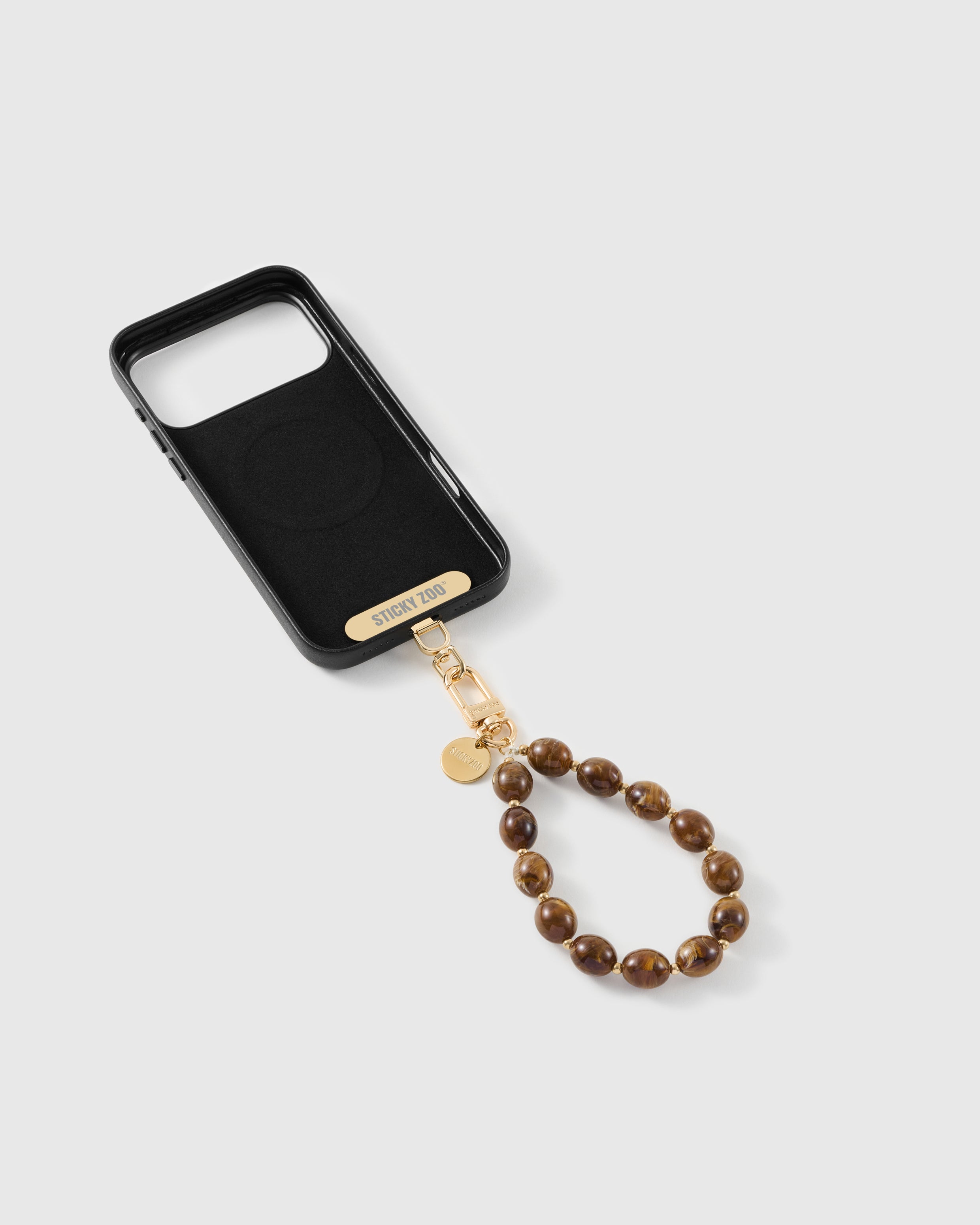 Amber swirl bead strap attached to a phone case with the included Phone Strap Card