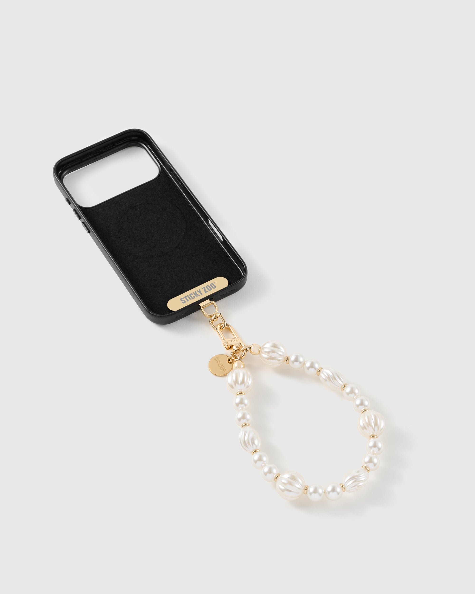 Inside of a phone case showing the included Phone Strap Card that adds a strap to any case, 100,000+ sold