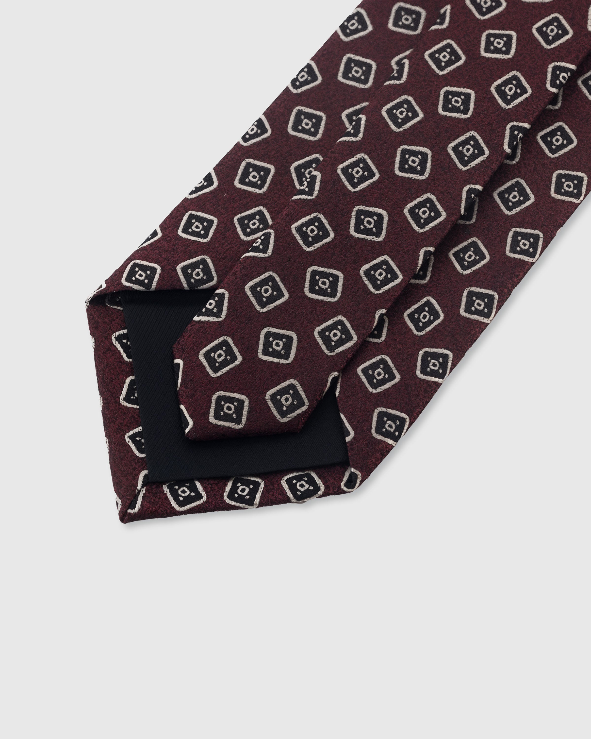 {Hand-finished interior} STICKYZOO BURGUNDY SQUARE FOULARD TIE back detail showing structured interlining and hand-finished slip stitching, 145 x 8 cm
