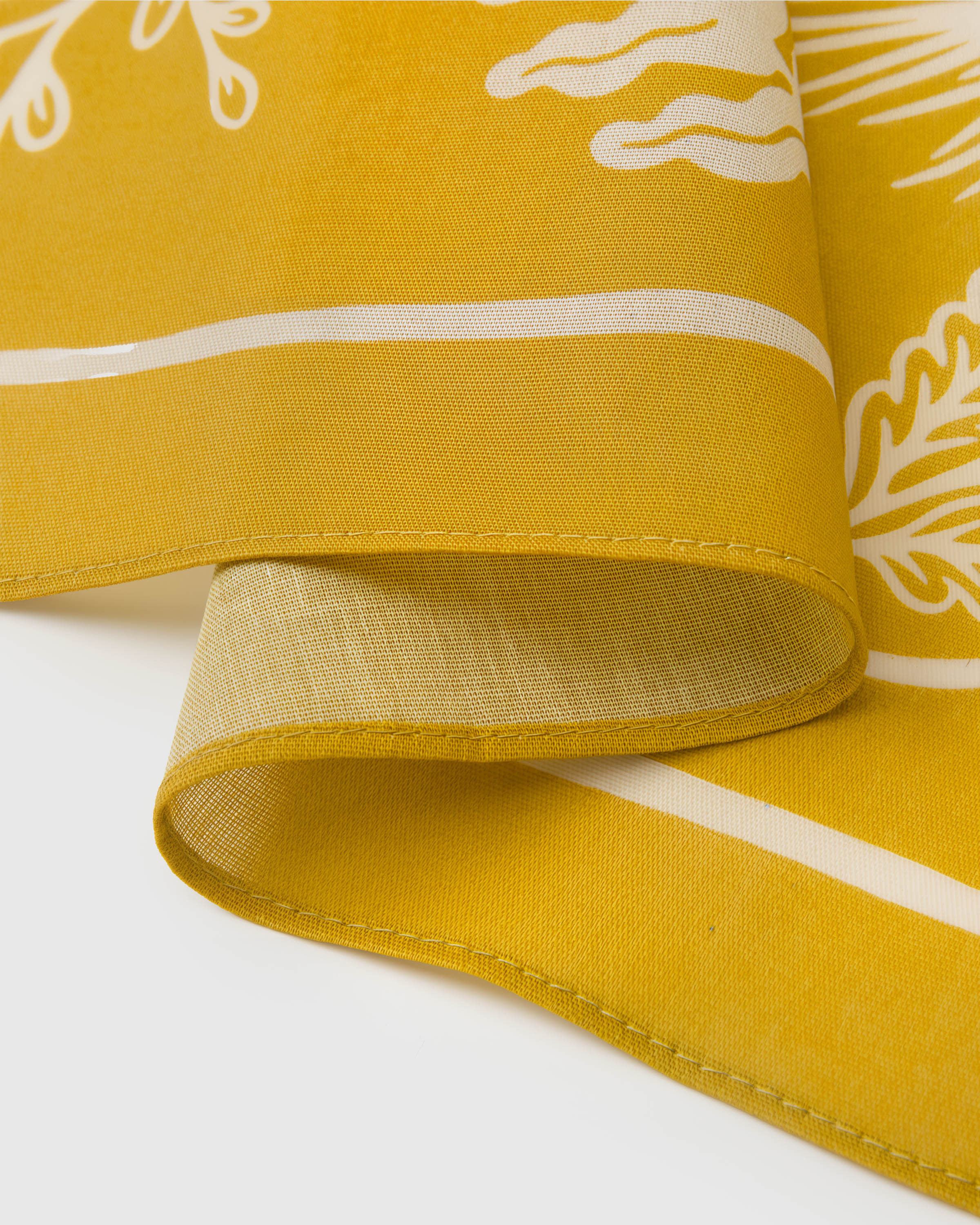 STICKYZOO mustard herbarium silk scarf edge showing the ivory border line on pure silk