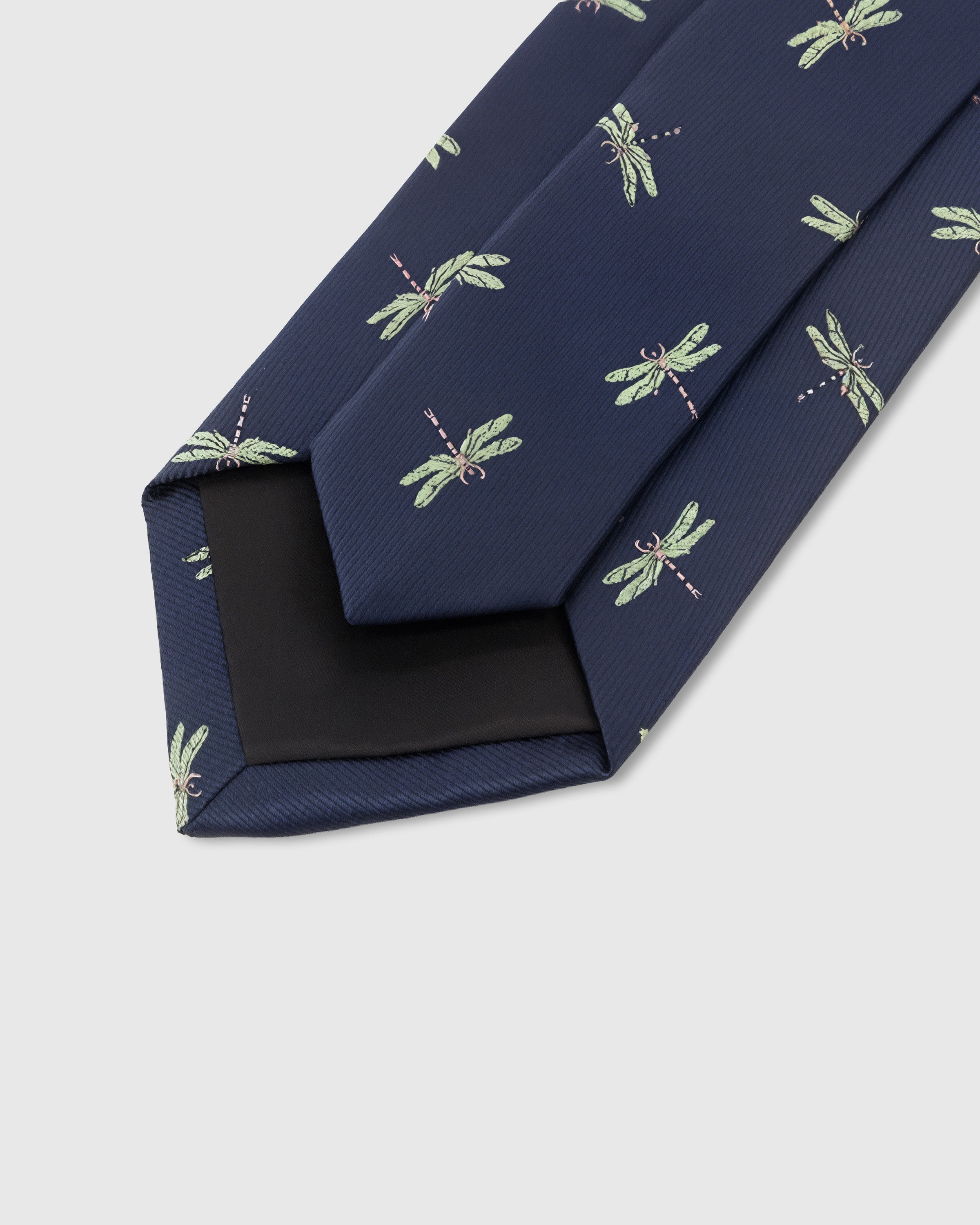 STICKYZOO Navy Dragonfly Tie construction detail showing structured interlining and hand-finished slip stitching, rated 4.9 stars