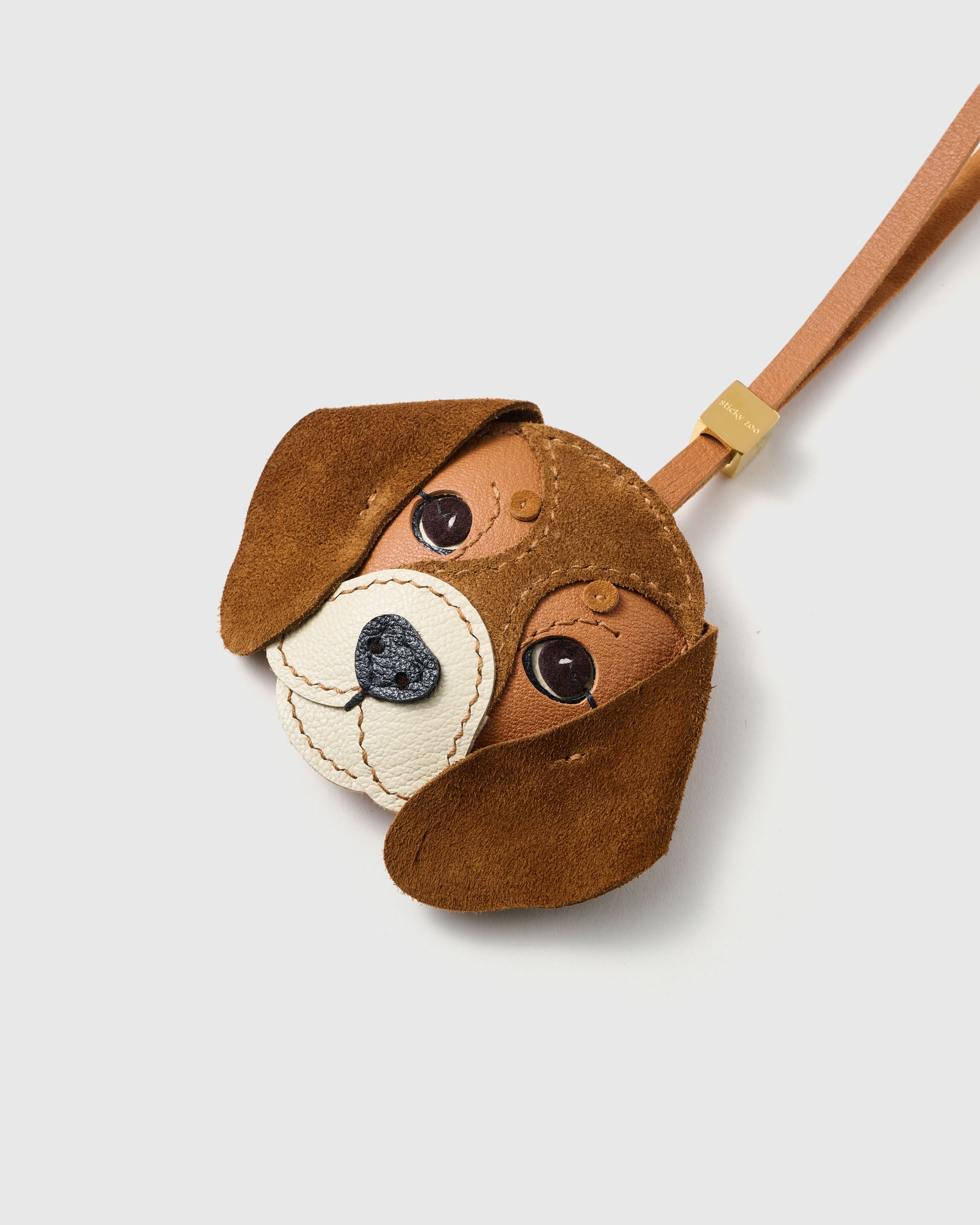 {{Hand-cut. Hand-stitched.}} layered French Alran goatskin leather, alcantara suede ears, heart-shaped textured nose — every panel shaped by hand. 72 hours of craft per piece.