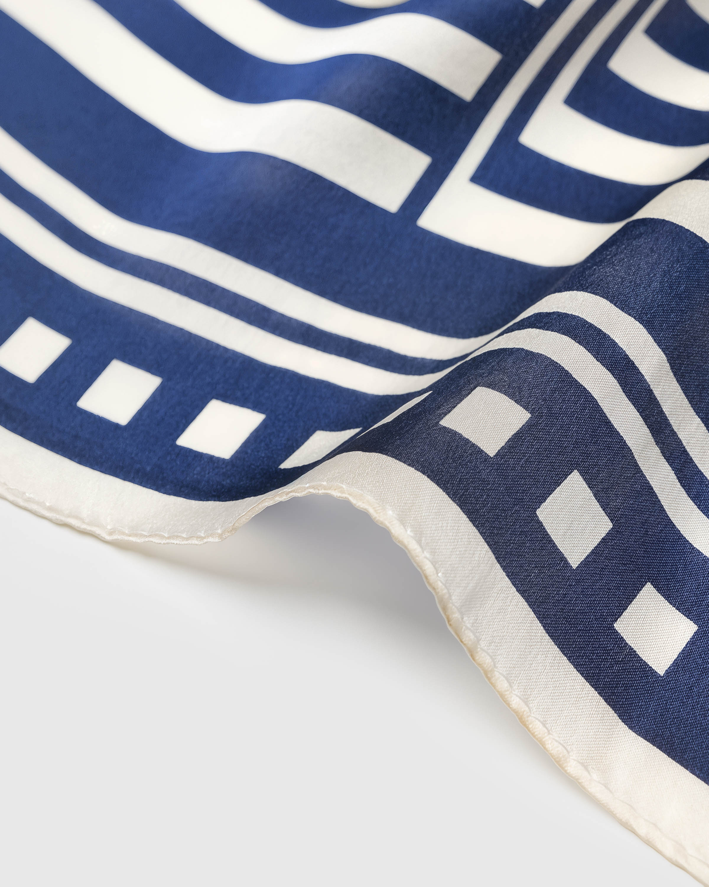 Hand-illustrated chevron motif printed in archival ink across the silk square fold
