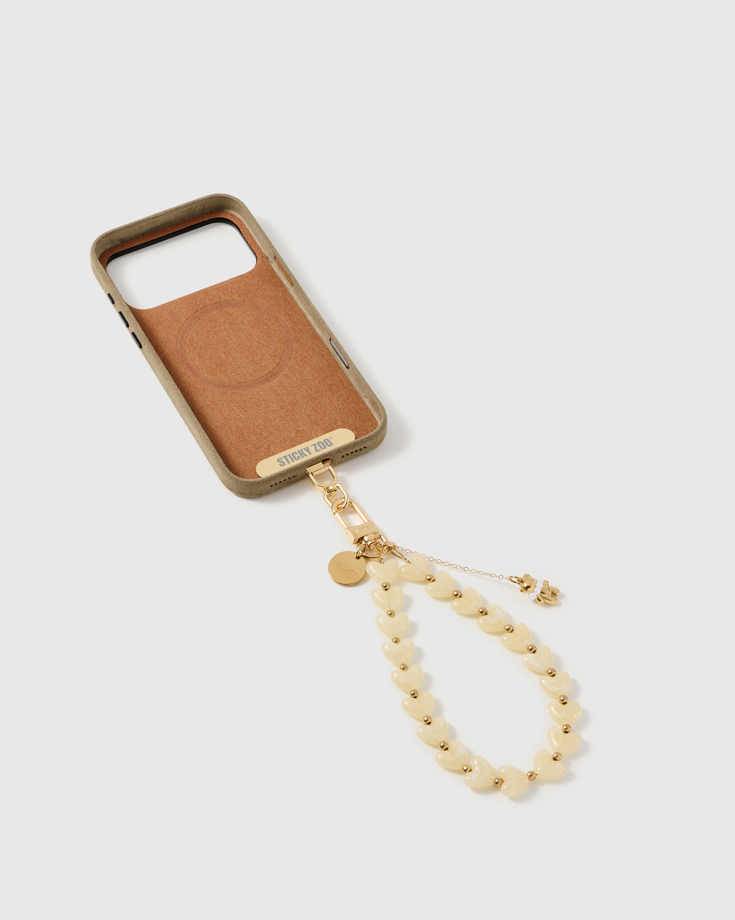 Back of an opened phone case showing the STICKYZOO Phone Strap Card slotted in — universal compatibility. 5,000+ Reviews.