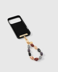 Full phone with mixed agate stone strap attached on light background