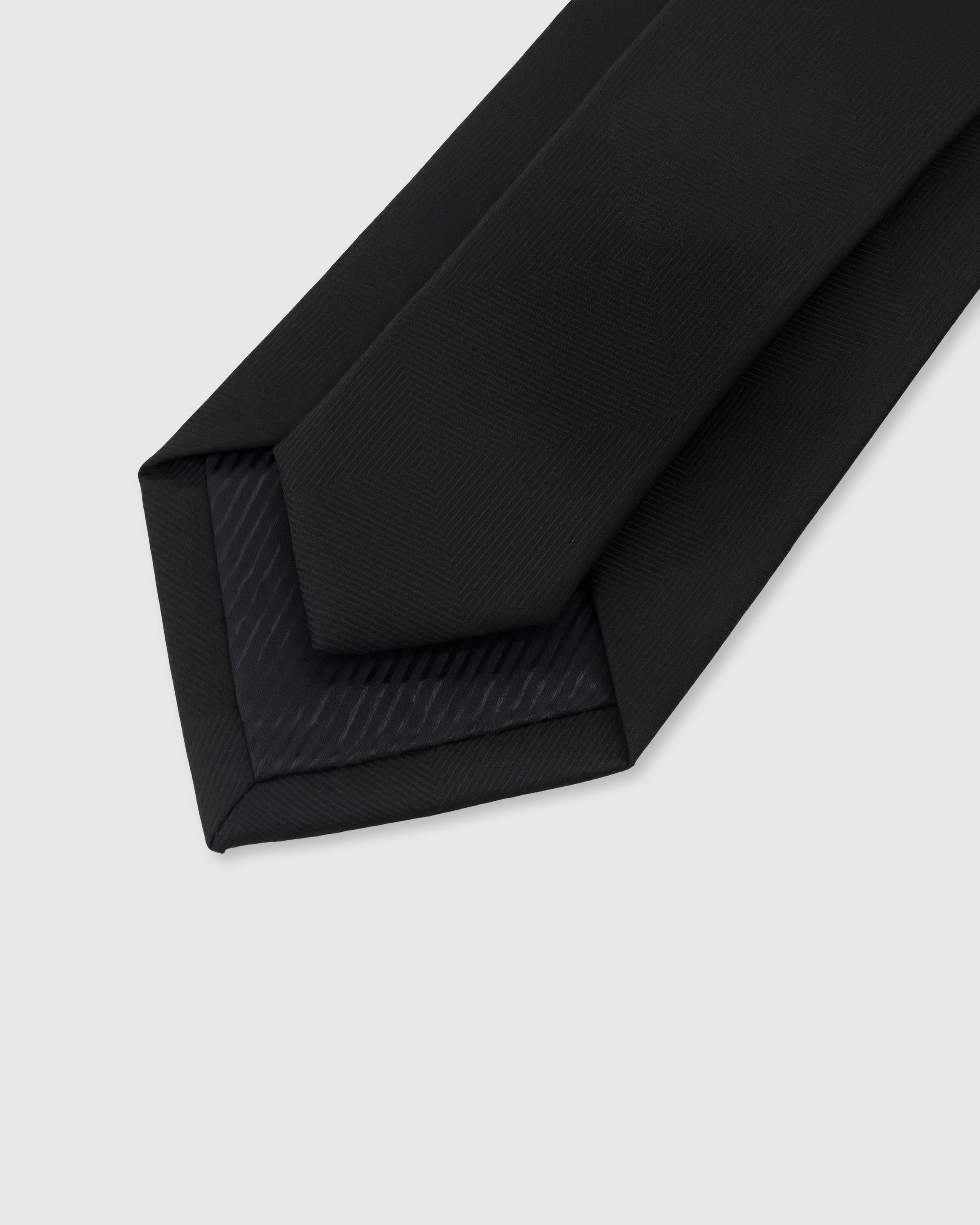 {Hand-finished interior} STICKYZOO ONYX HERRINGBONE TIE back detail showing structured interlining and hand-finished slip stitching, 145 x 8 cm