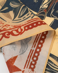 Close-up of the scalloped red-ochre border on the cowgirl rider silk scarf showing the silk weave