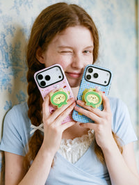 Pink and blue green-hood cat grip cases held together, each with a 3D cat-face pop-grip on the back.