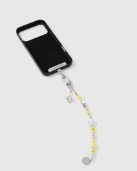 Close-up of silver-tone engraved clasp and STICKYZOO charm disc with yellow beads