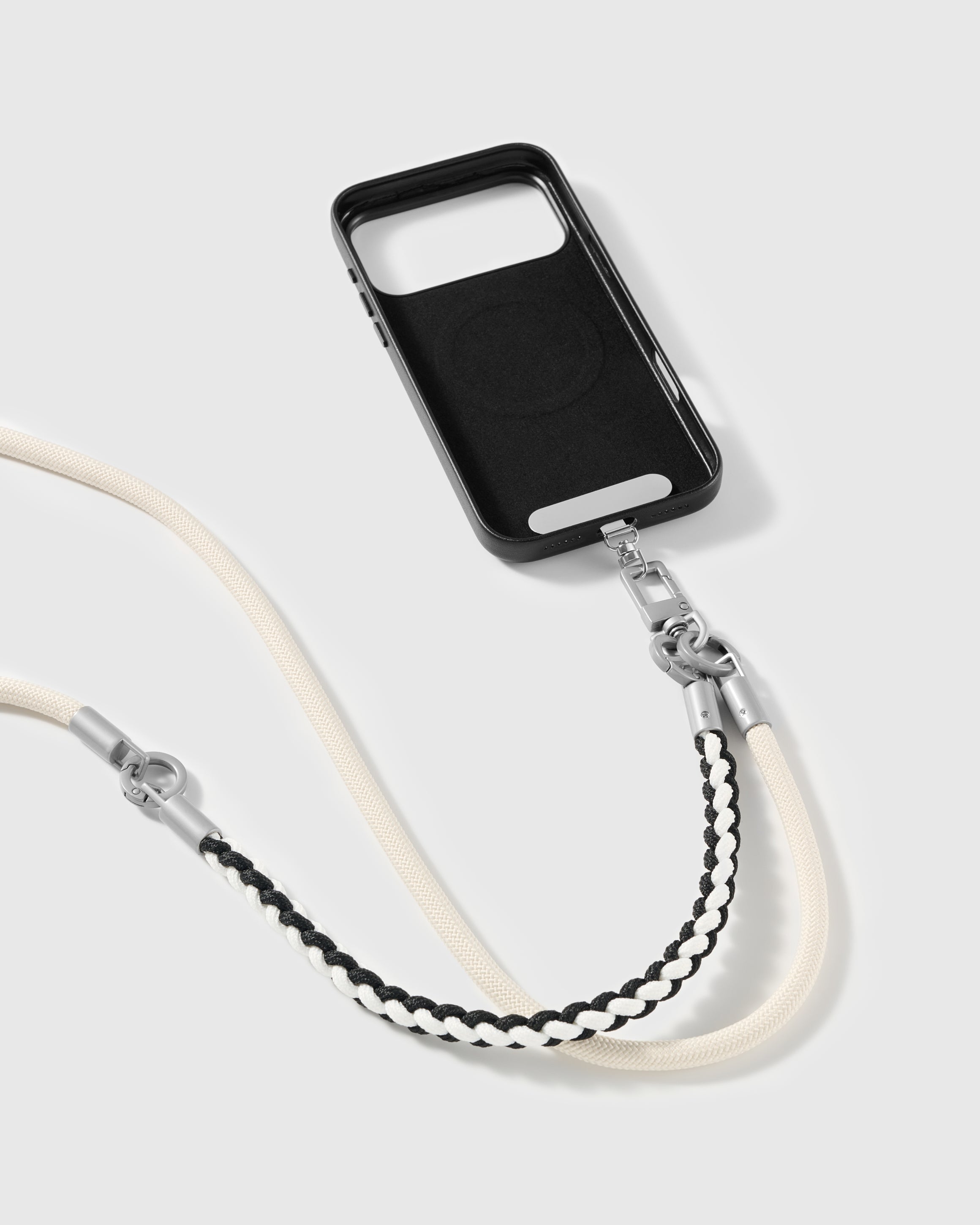 Ivory strap clipped to a black phone case for hands-free carry
