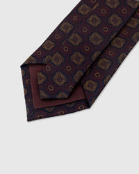 STICKYZOO Claret Quatrefoil Tie construction detail showing 45° bias cut, structured interlining and slip stitching, 145 x 8 cm