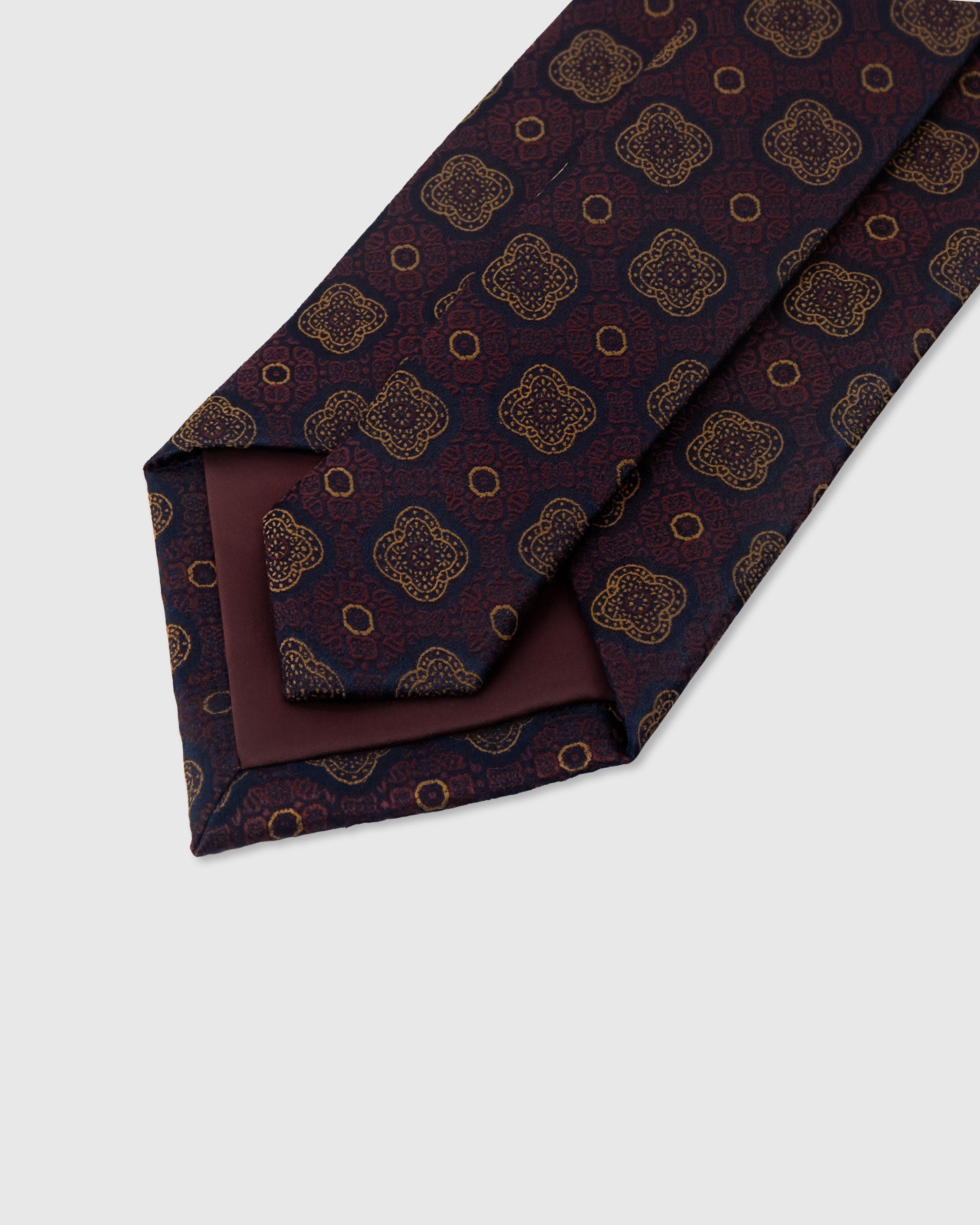 STICKYZOO Claret Quatrefoil Tie construction detail showing 45° bias cut, structured interlining and slip stitching, 145 x 8 cm