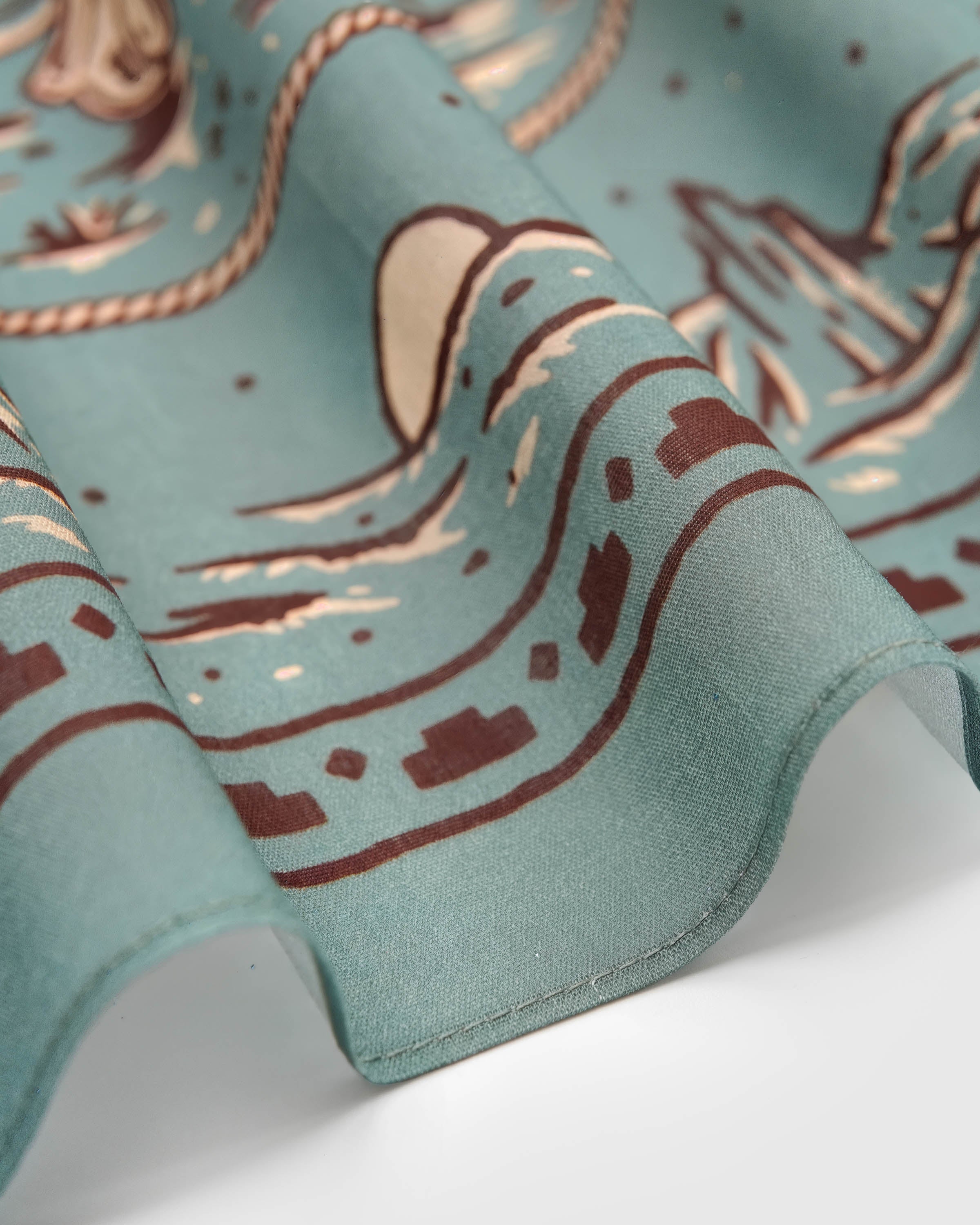 Close-up of the hand-illustrated western motif printed in archival inks on pure silk