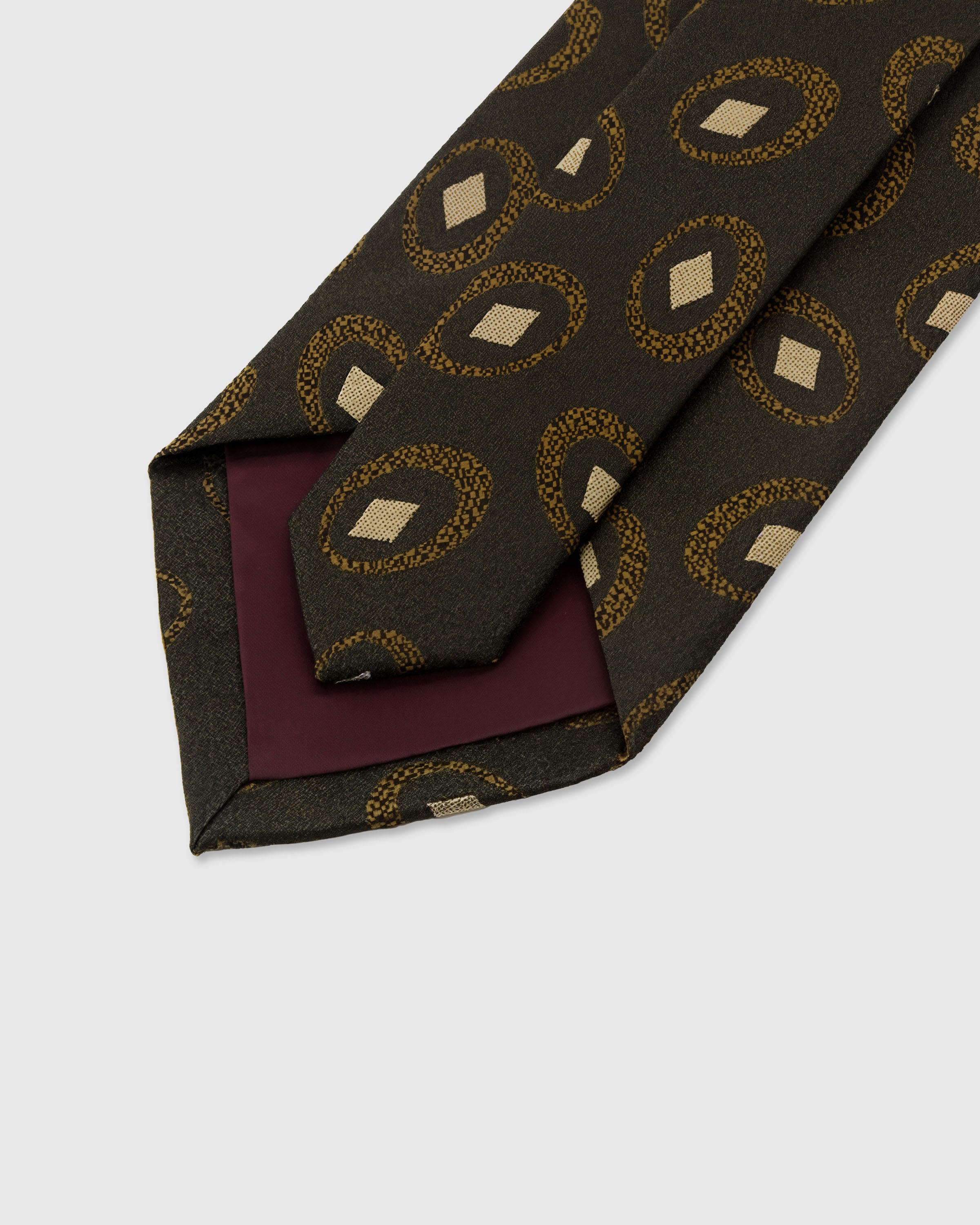STICKYZOO Umber Medallion Tie construction detail showing structured interlining and hand-finished slip stitching, 145 x 8 cm