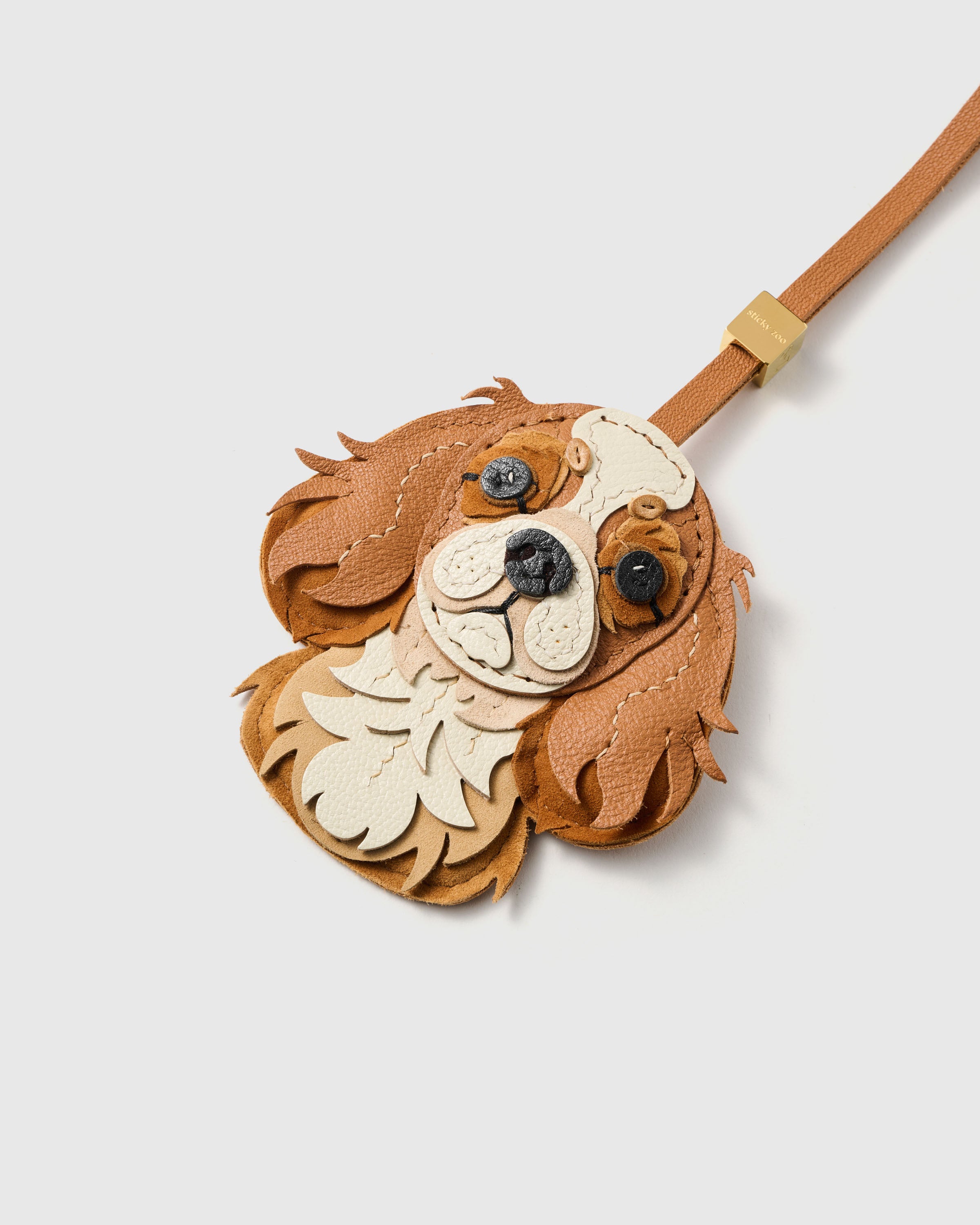 {{Hand-cut. Hand-stitched.}} Layered French Alran goatskin and alcantara suede panels — wavy spaniel ears, petal-shaped chest ruff, every piece shaped by hand.