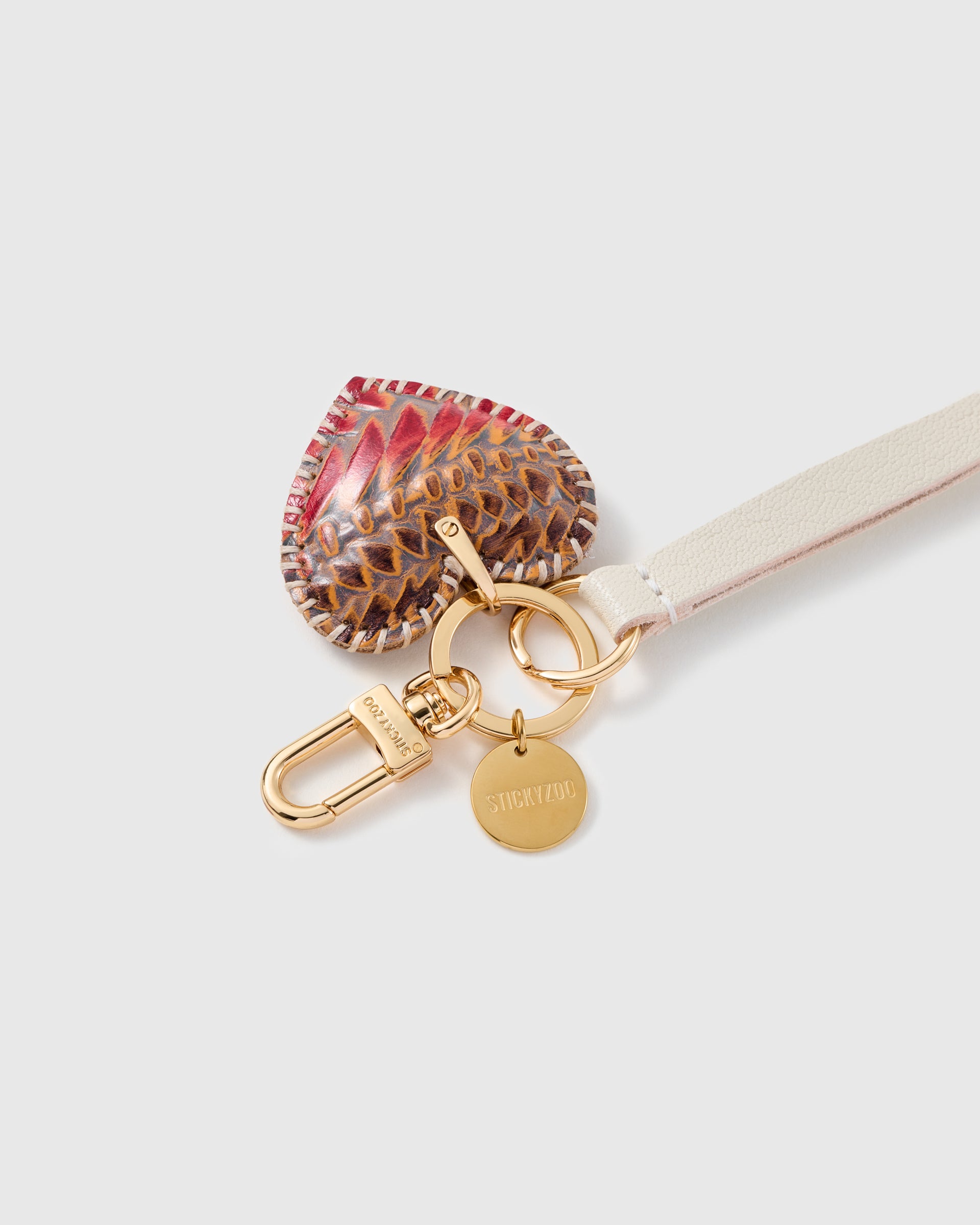 Close-up of the STICKYZOO ember python calf-hair heart, hand whip-stitched edge and hand-cut leather