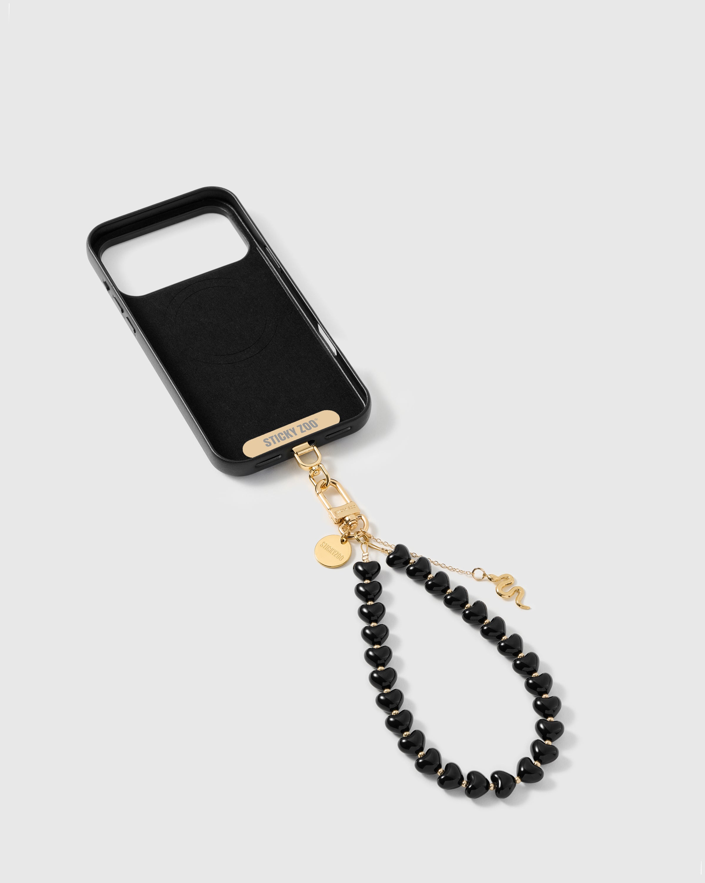 Phone Strap Card included STICKYZOO inside the phone case showing the universal strap card with gold-plated hardware