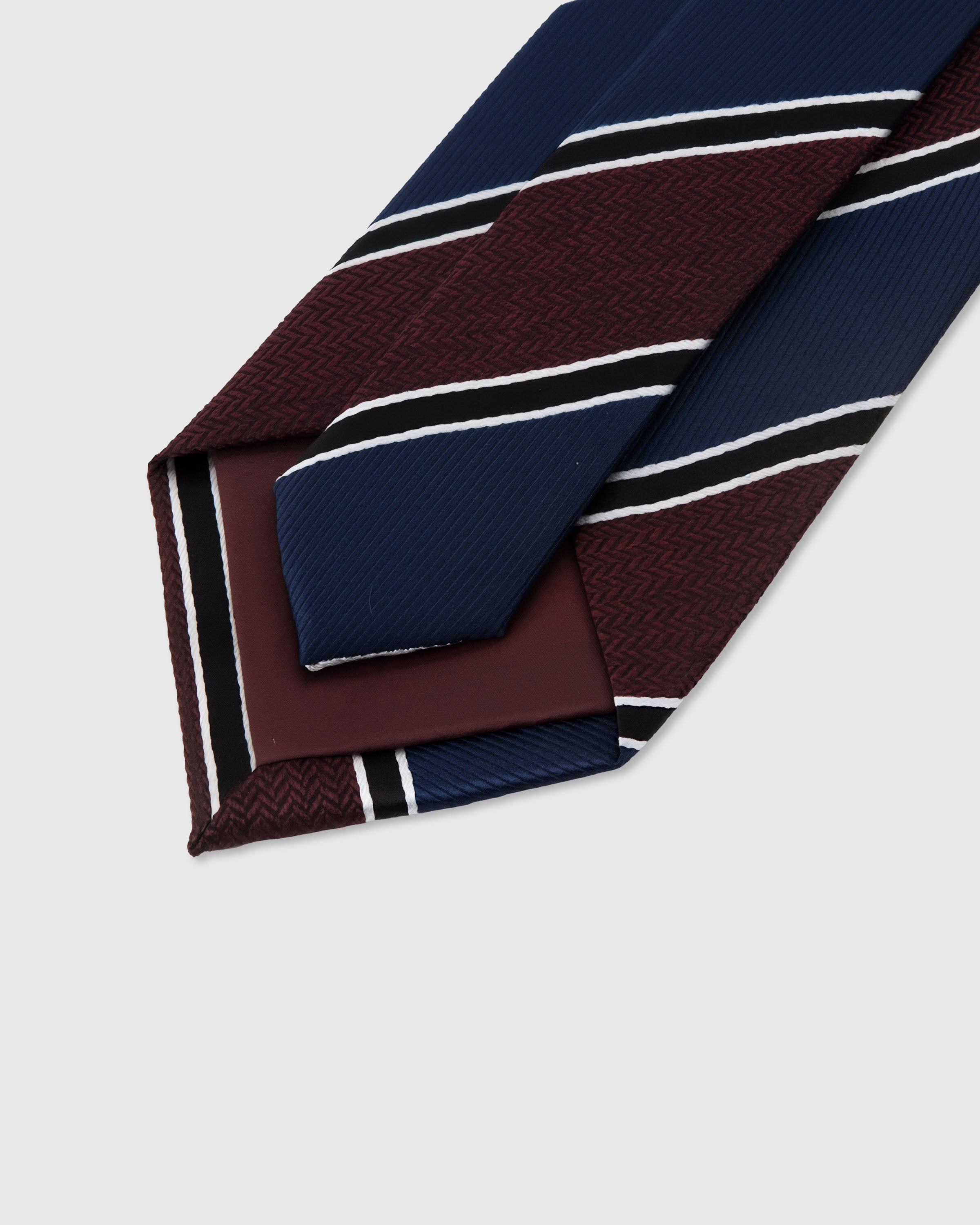 STICKYZOO Claret Regiment Tie construction detail showing structured interlining and hand-finished slip stitching, 145 x 8 cm