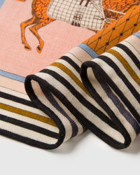 STICKYZOO horse-blanket silk scarf swirled to show the soft drape and saffron-and-orange palette